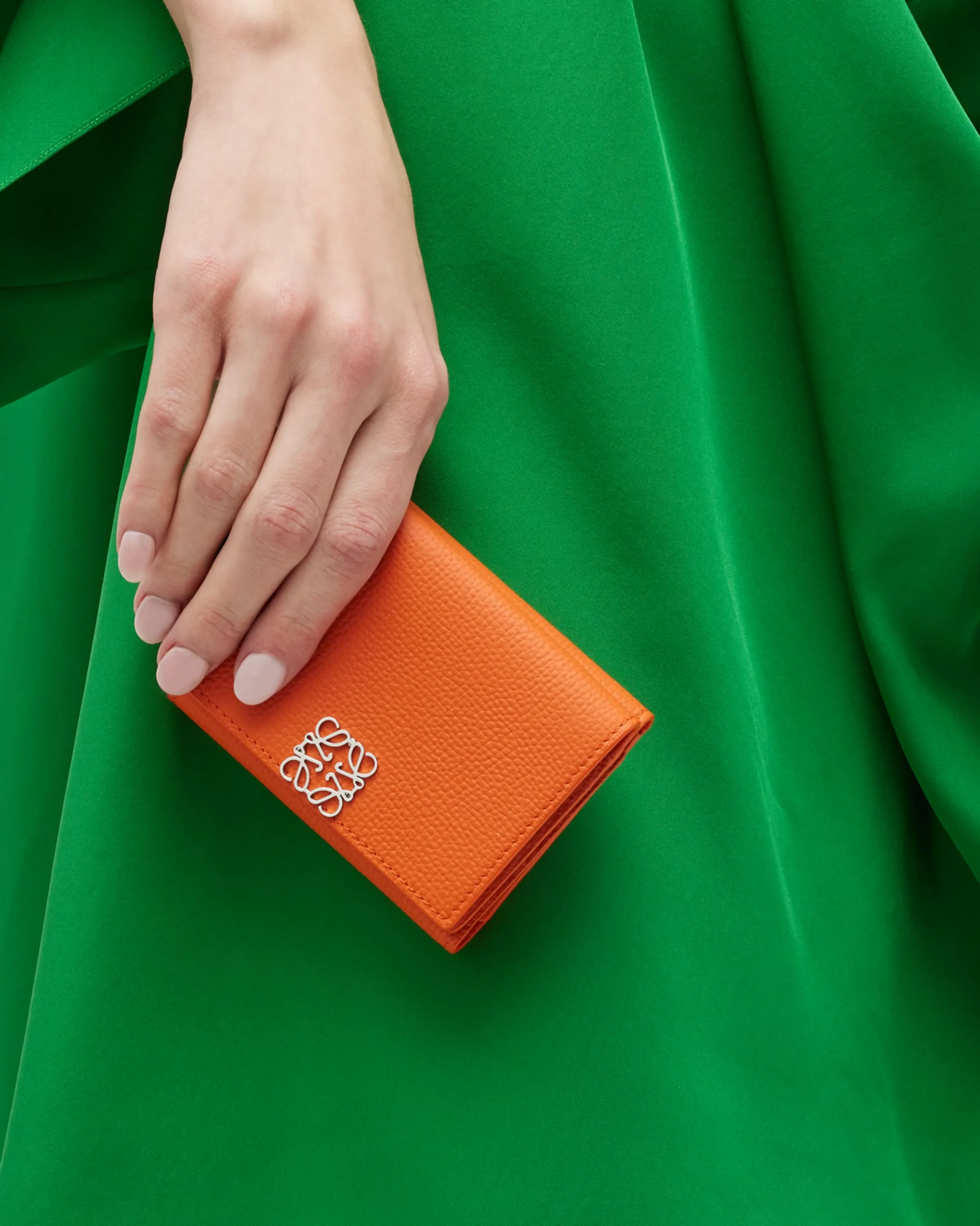 Ghost image of a Loewe orange leather wallet