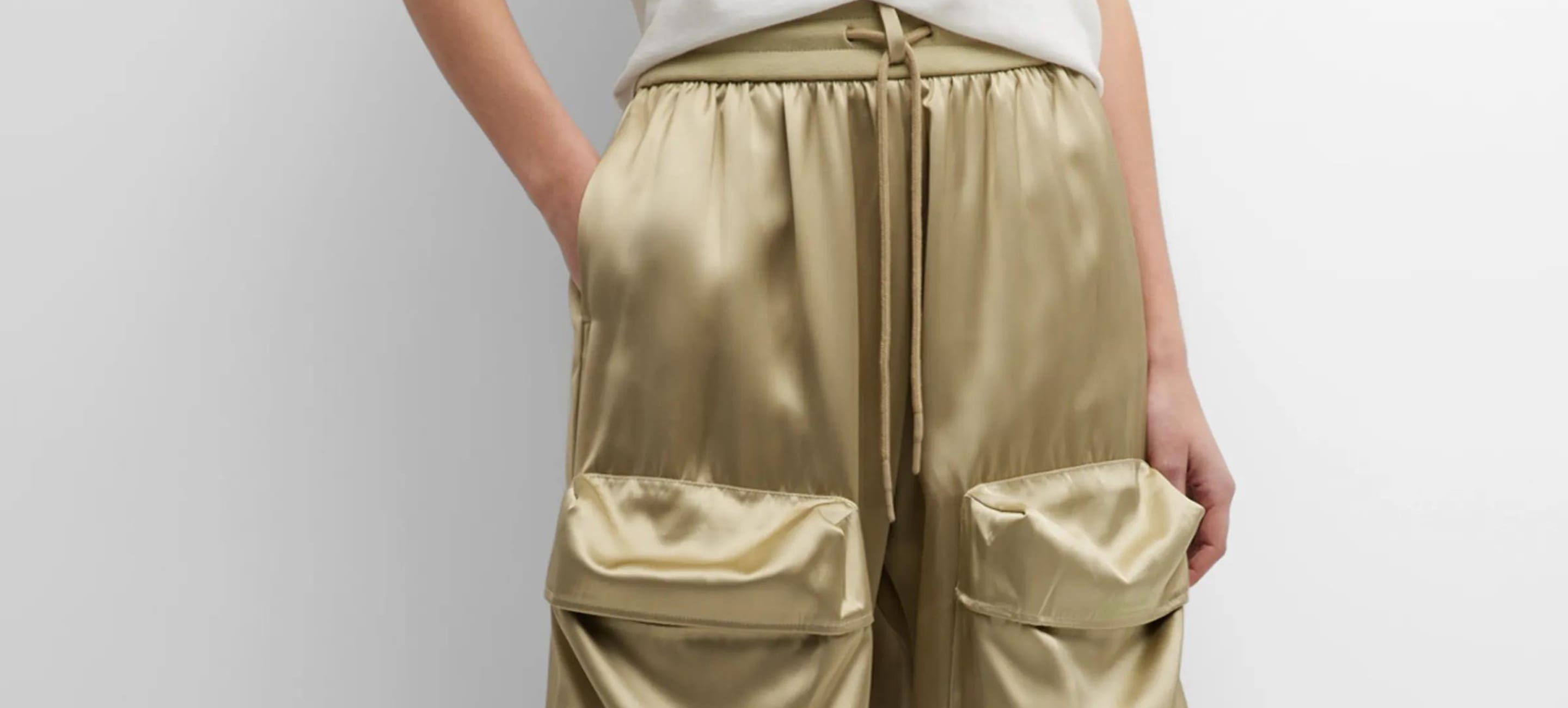 Closeup of golden satin cargo pants