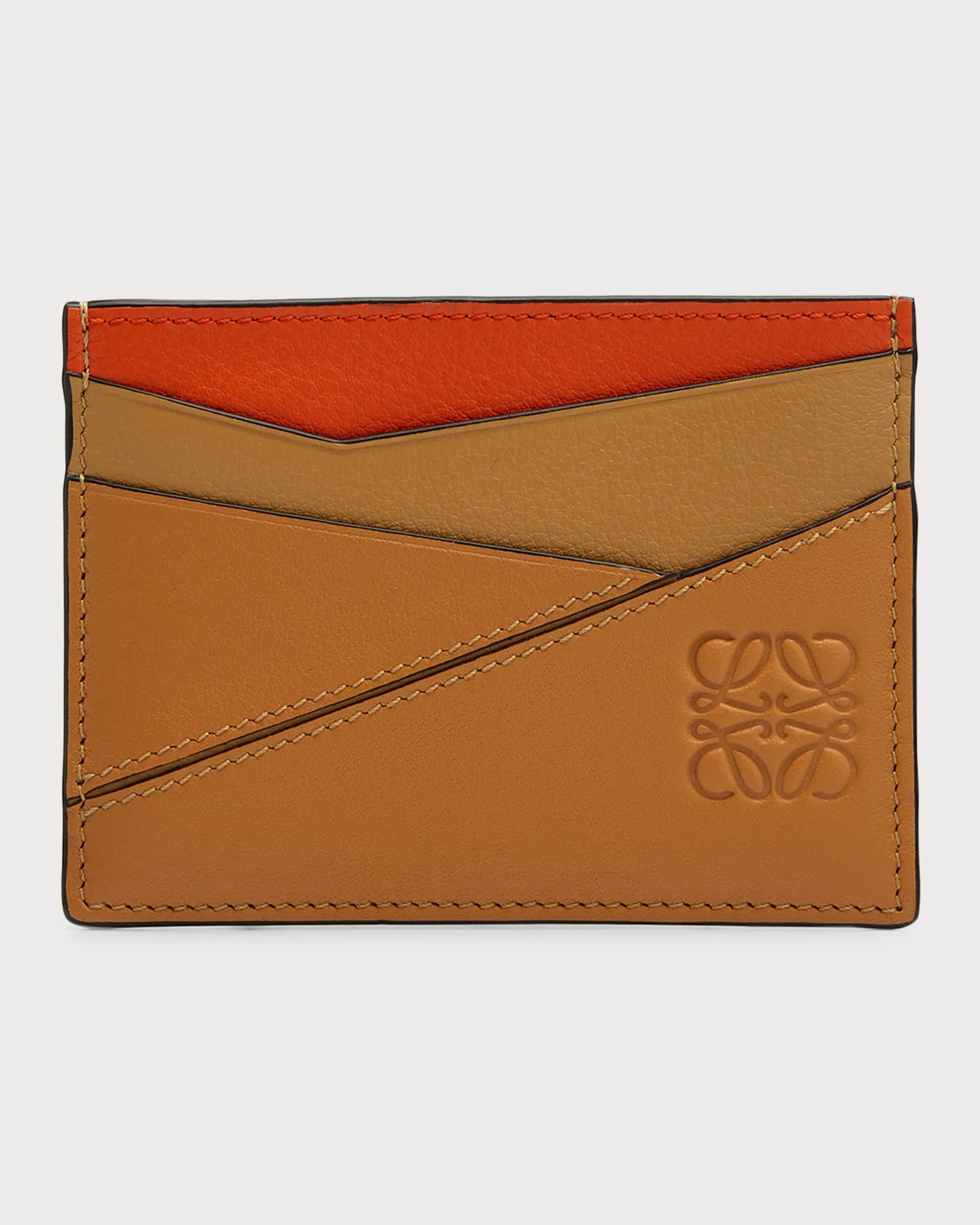 Ghost image of a Loewe warm desert/orange leather card holder