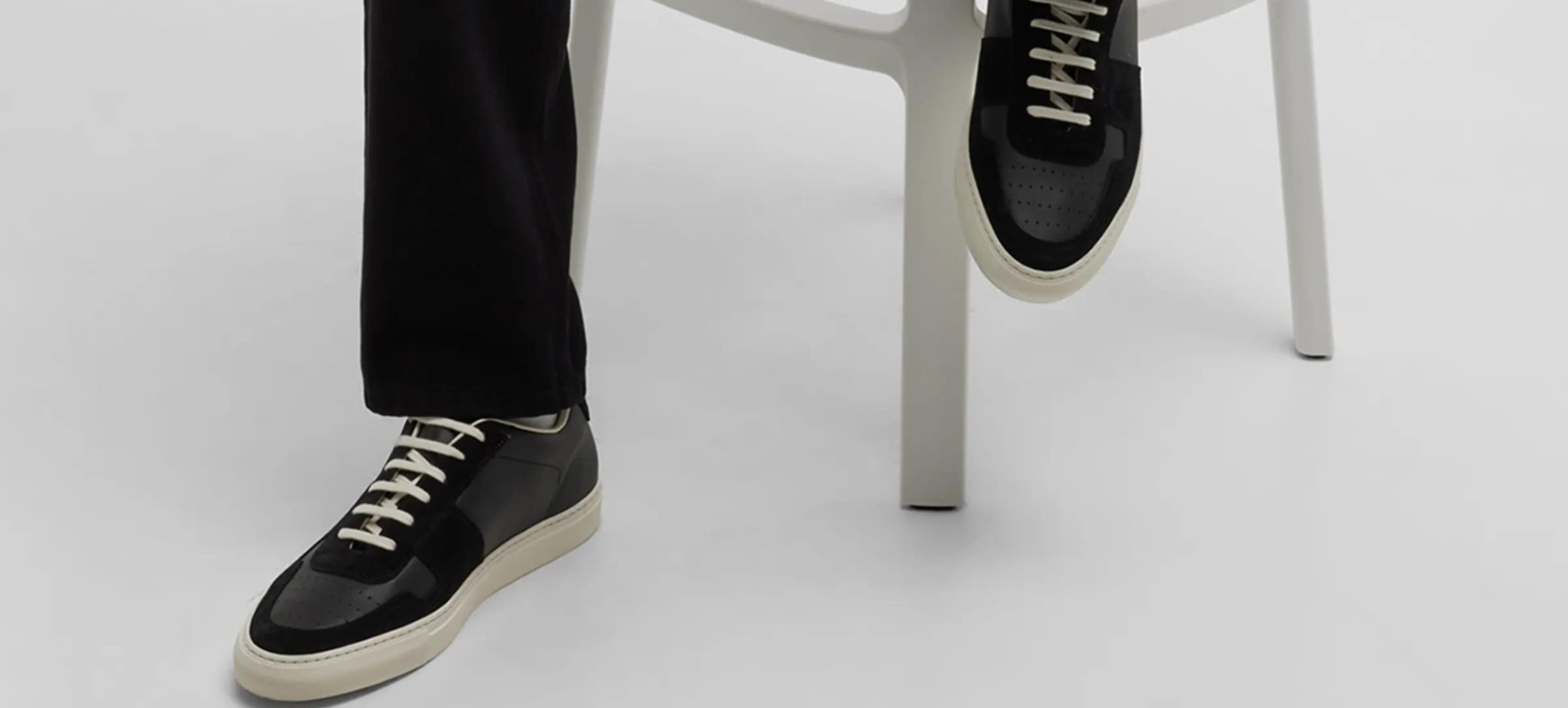 person wearing leather all black sneakers