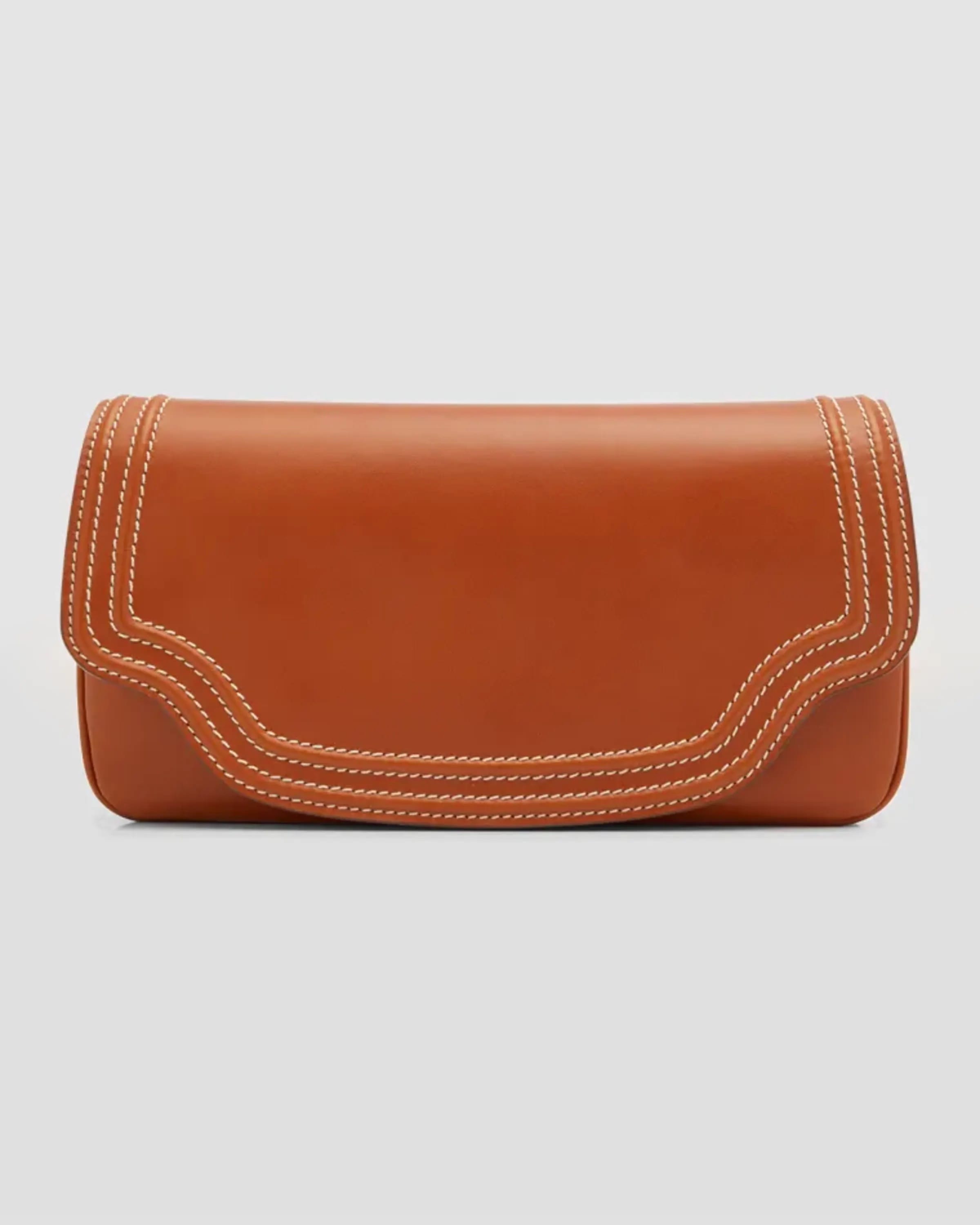 Ghost image of a Loro Piana warm tan leather clutch