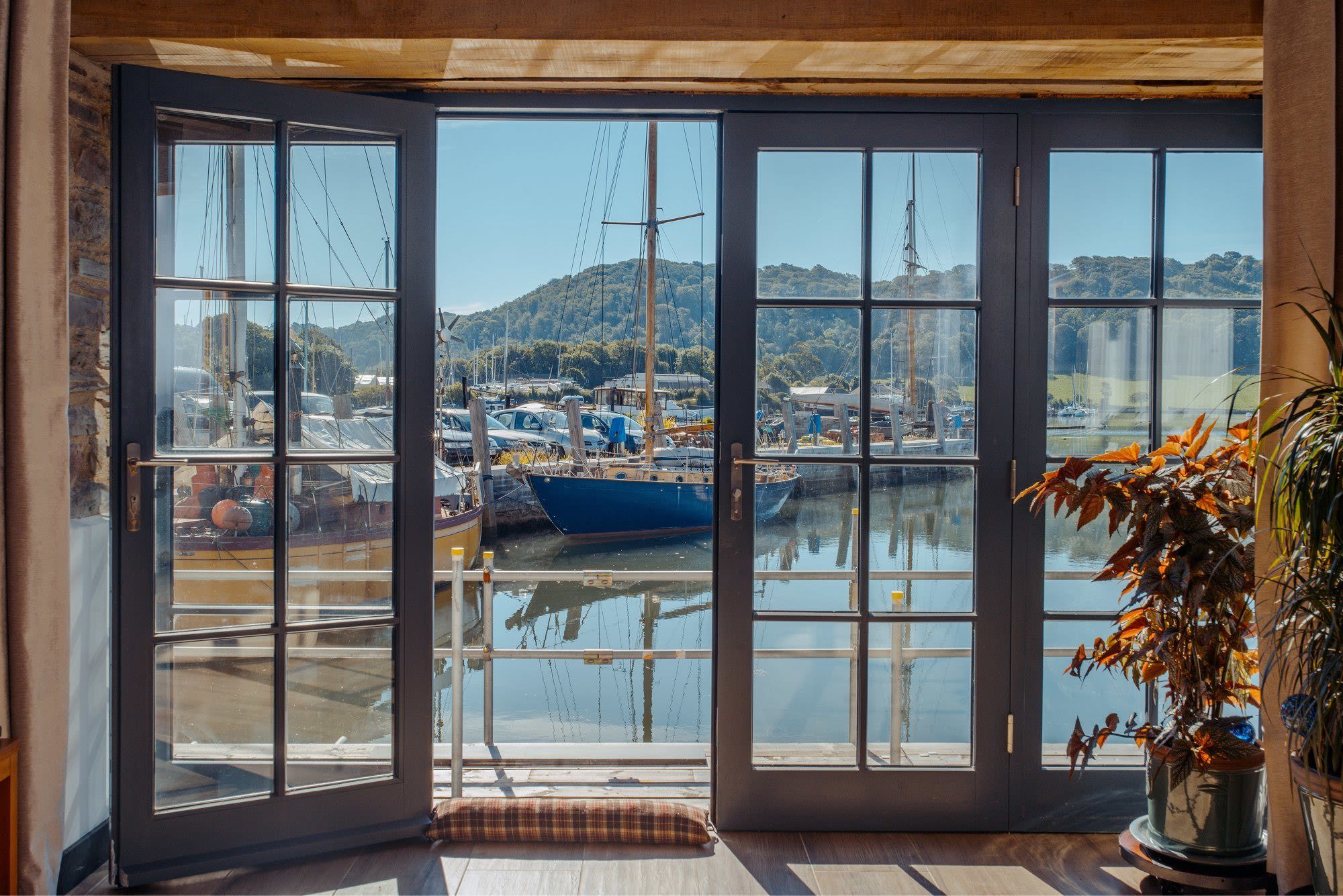 The Best Wood Replacement Windows For Coastal Homes | Nathan McCarter Joinery bespoke timber double doors by the sea