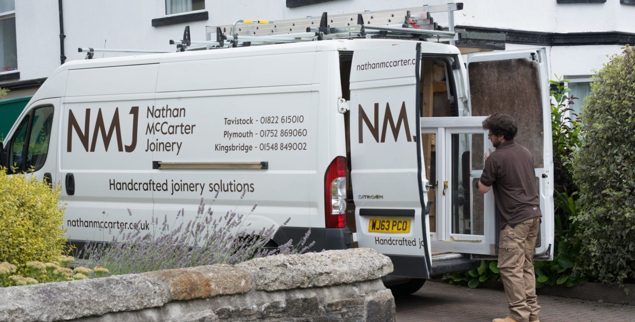 Nathan McCarter staff delivering a bespoke timber window made with Accoya wood
