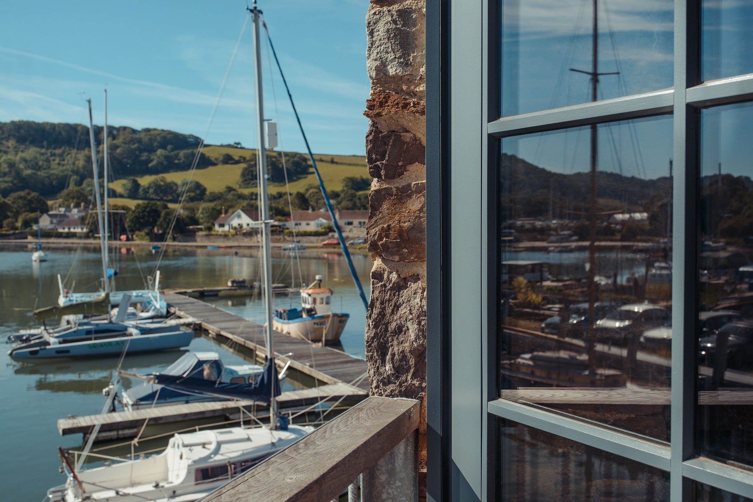 The Best Wood Replacement Windows For Coastal Homes | Nathan McCarter Joinery open custom wooden window outlooking the sea