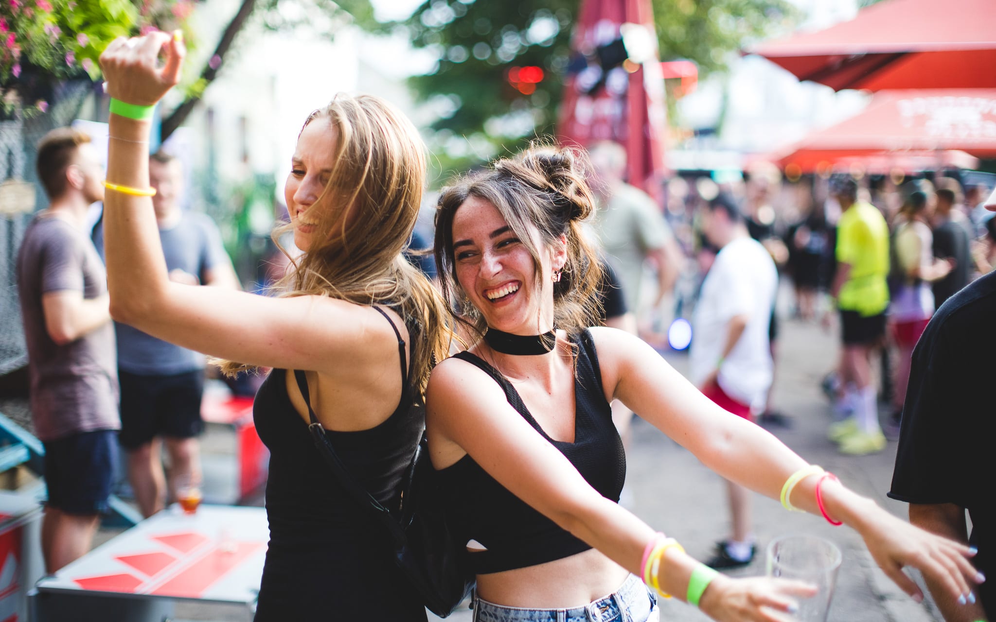 Two women with brown hair dancing, enjoying the party, and posing