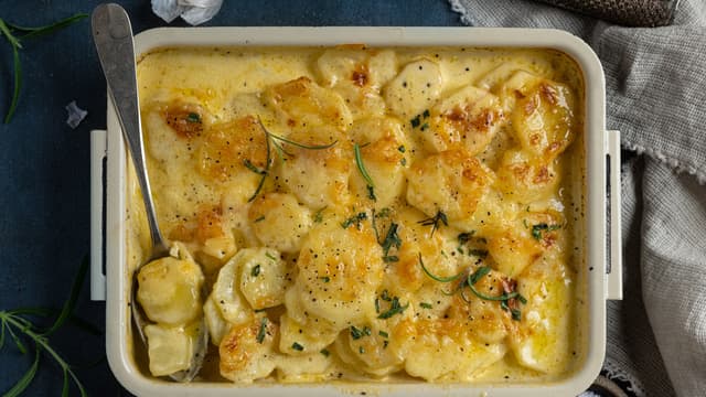 **Stekes midt i ovnen på 200 grader i ca. 30 minutter.** Ha så revet parmesan på toppen og stek det videre i ytterligere ca. 20 minutter til osten har smeltet og fått gyllen farge og potetene er møre.