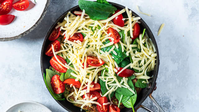 **Lag pizzafyll:** Del tomatene i to og topp squashpizzaen sammen med spinat og revet ost. Sett på lokket og stek til pizzaen er gjennomstekt og osten er smeltet.