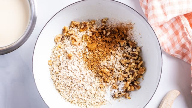**Havregrynblanding:** Bland sammen nøtter, havregryn, bakepulver, kanel og salt i en bolle.