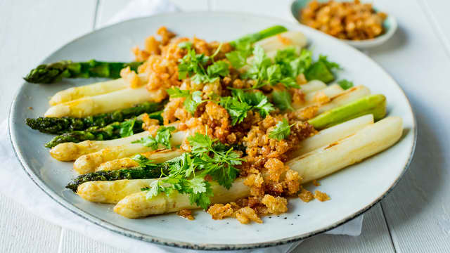 Legg aspargesen på et fat eller fordel dem på tallerkener. Dryss over sprø smuler og pynt med kjørvel.