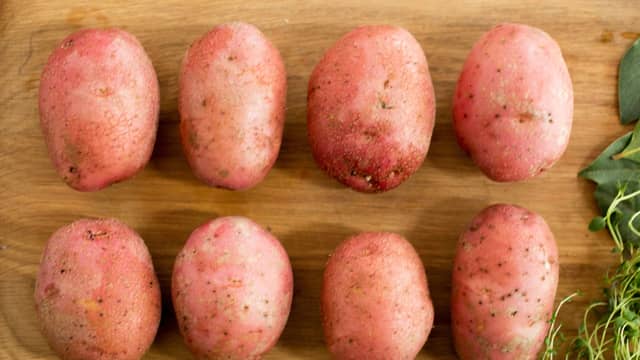 **Hasselbackpoteter:** Sett stekeovnen på 225 grader. Vask og tørk potetene. Skjær tynne skiver nesten helt gjennom, og legg dem på et stekebrett.