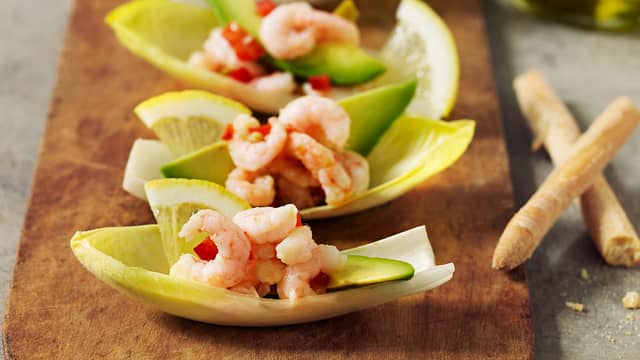 Anrettes blandingen i endiveblader og topp med en skive avokado.