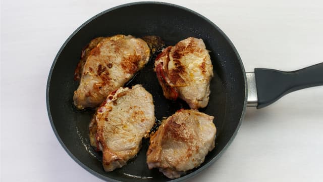 Vask og del salat. Server kotelettene med bakt løk og salat med sausen fra løkpannen.