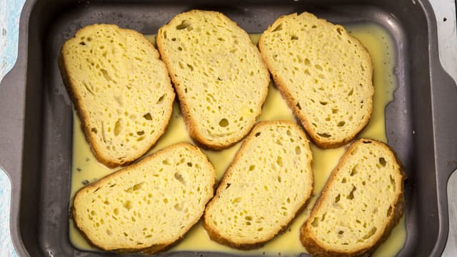 Hell blandingen i en form. Legg brødskivene i blandingen og la dem trekke godt inn på begge sider.