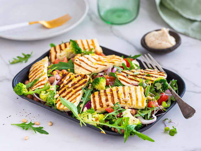 Anrett salaten på et fat og topp med grillet halloumi.