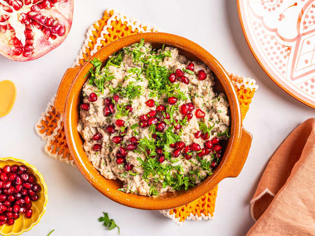 Anrett auberginedippen i en skål og topp med granateplefrø. Server med godt brød.