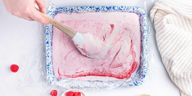Ha marshmallowsmassen I formen. Bre forsiktig utover med en slikkepott. Dryss til slutt litt ekstra melis over toppen.