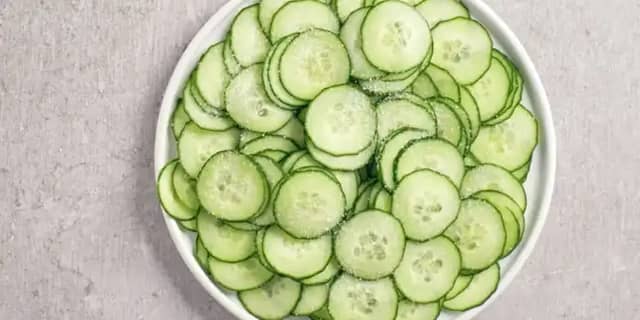 **Lag agurk- og løksalat:** Skjær agurken i tynne skiver med en ostehøvel og rødløken i ringer.