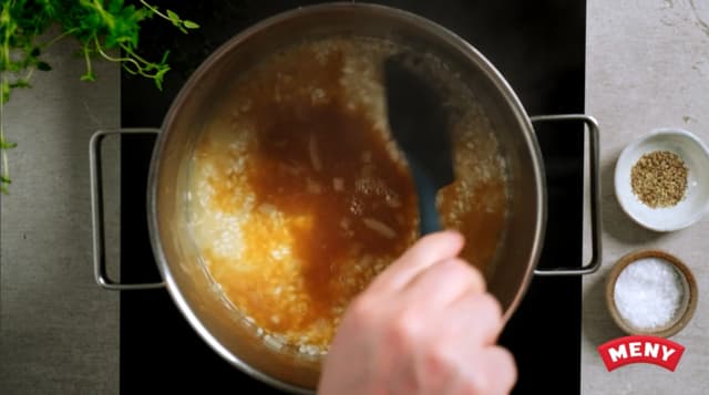 Tilsett ca. 1,5 dl kraft og rør godt om. Sett ned varmen slik at risottoen småputrer. Tilsett små porsjoner kraft i ca. 15-20 minutter, til alt er kokt inn.