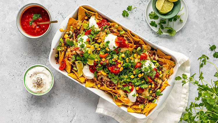 Loaded nachos i en liten langpanne står klar på et bord