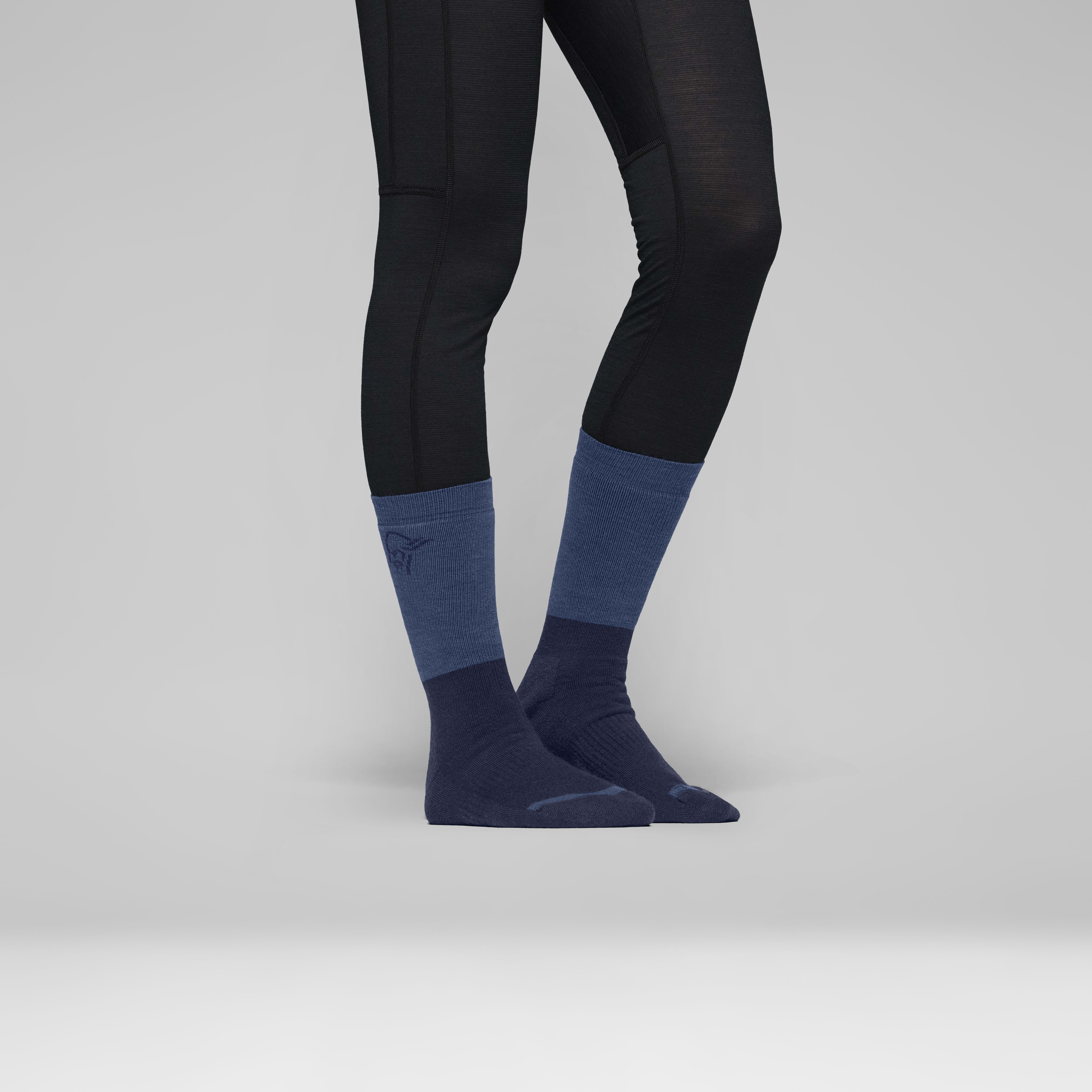 Female Look back image of trollveggen heavy merinoUll Socks Indigo Night/Dark Denim
