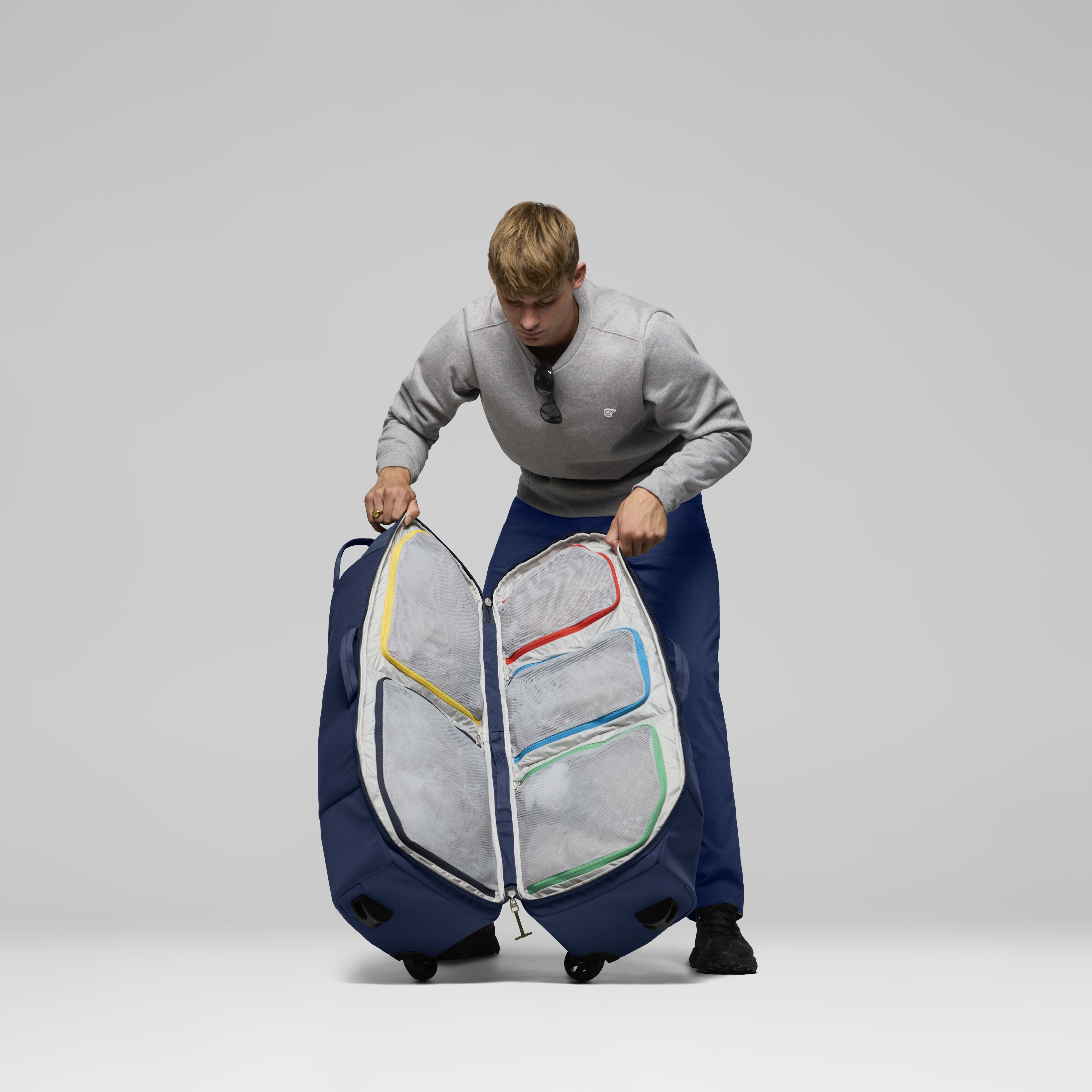Female Look back image of norrona dividable 125L Trolley Bag Indigo Night