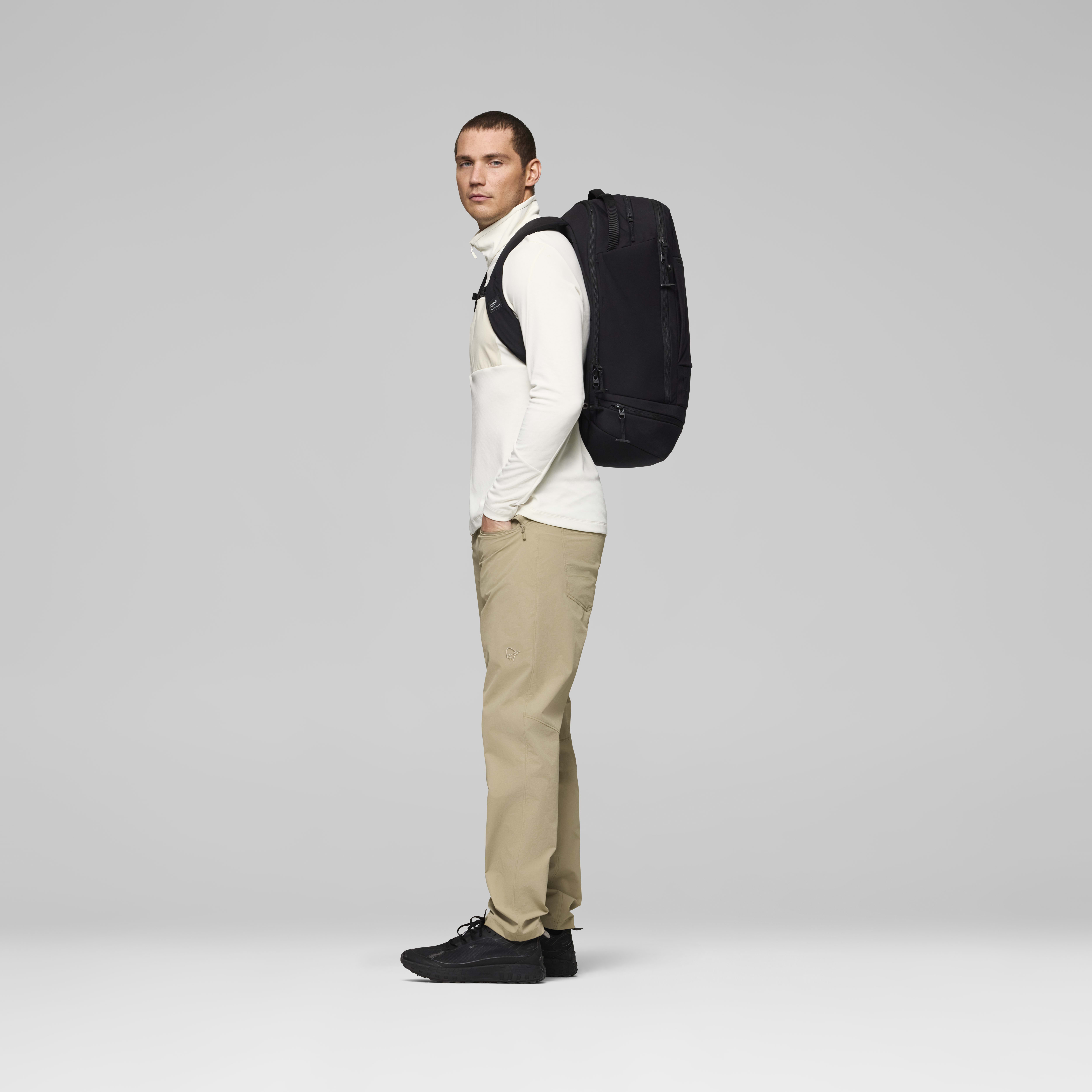 Female Look back image of norrona commuter 40L Pack Caviar Black
