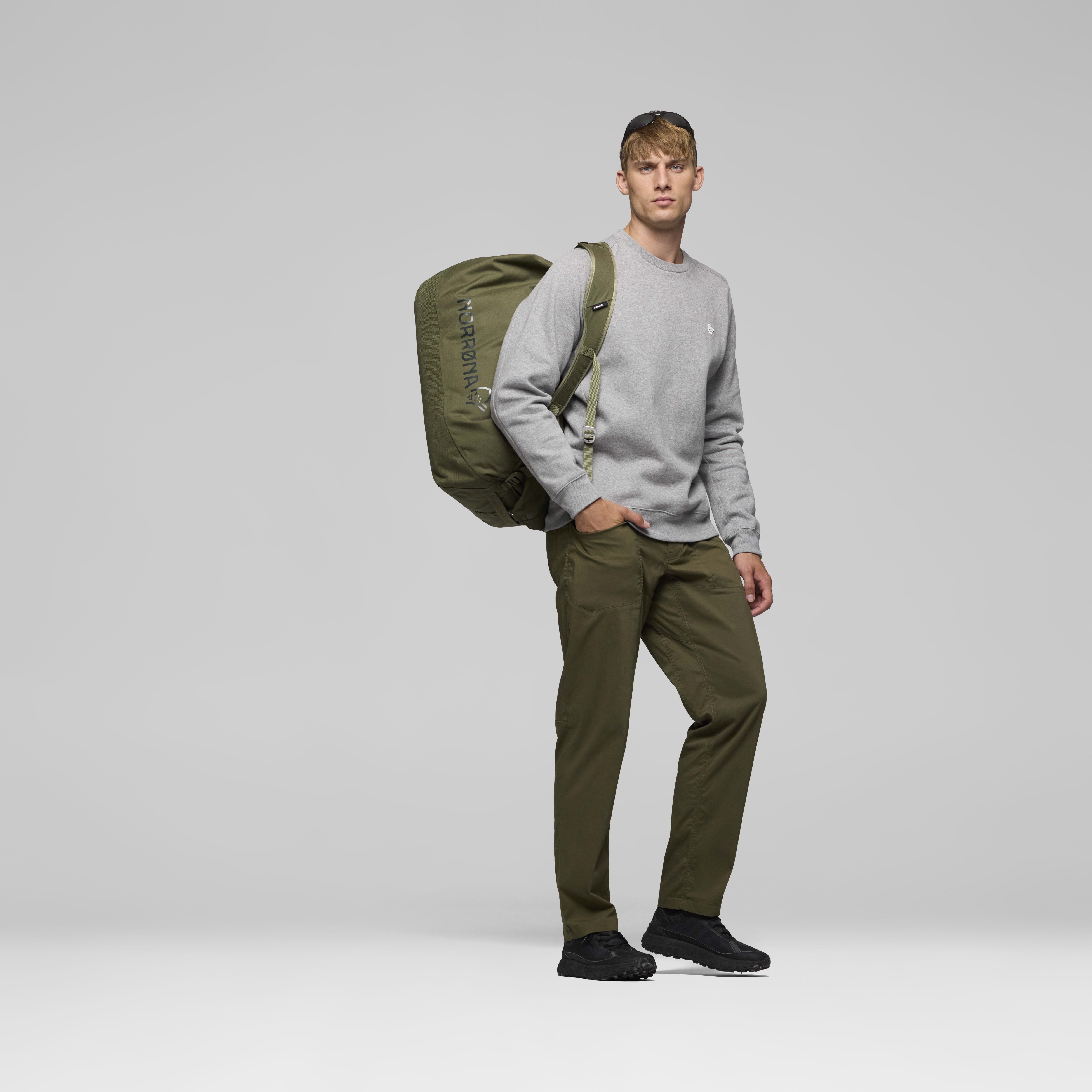 Female Look back image of norrona 70L Duffel Bag Olive Night