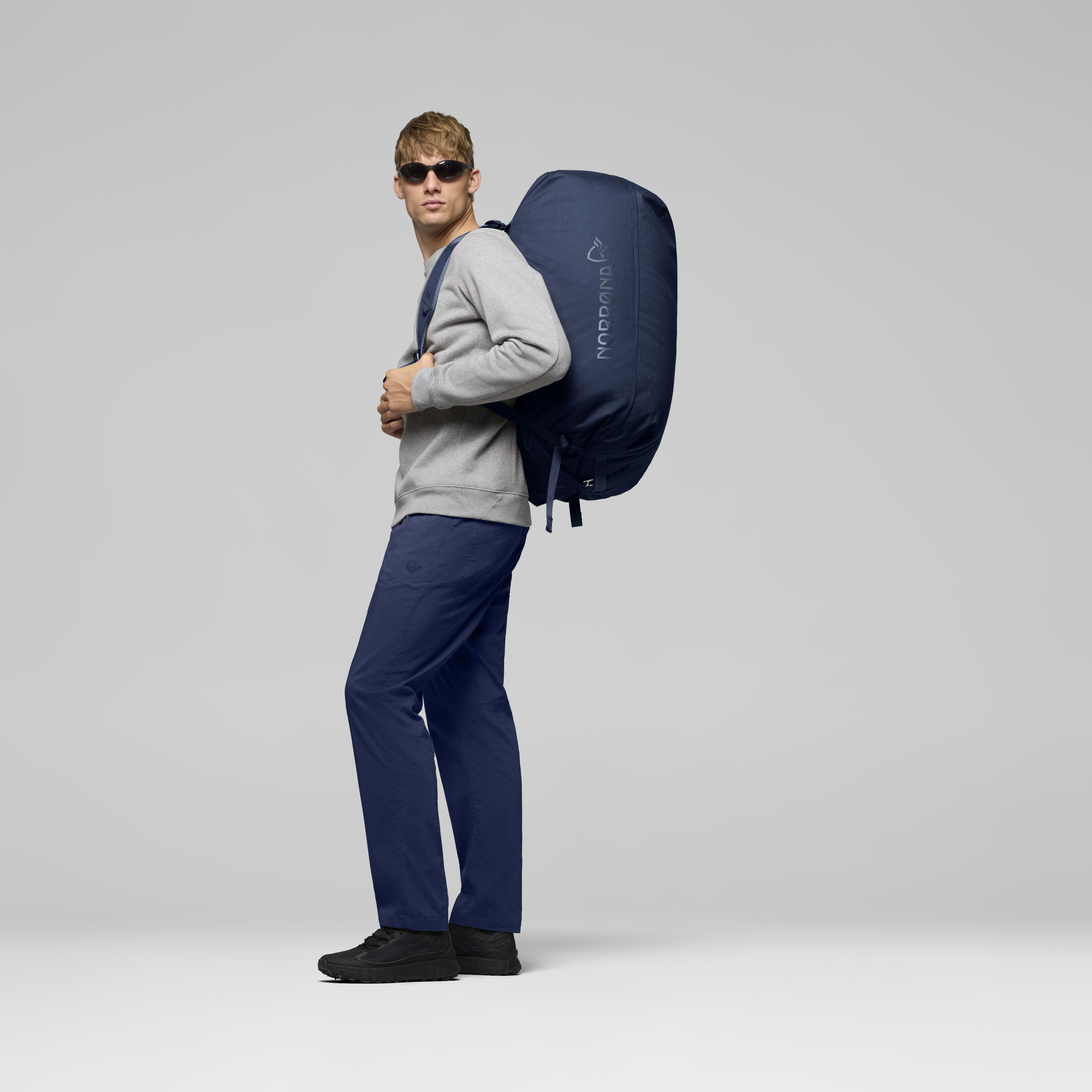 Female Look back image of norrona 90L Duffel Bag Indigo Night