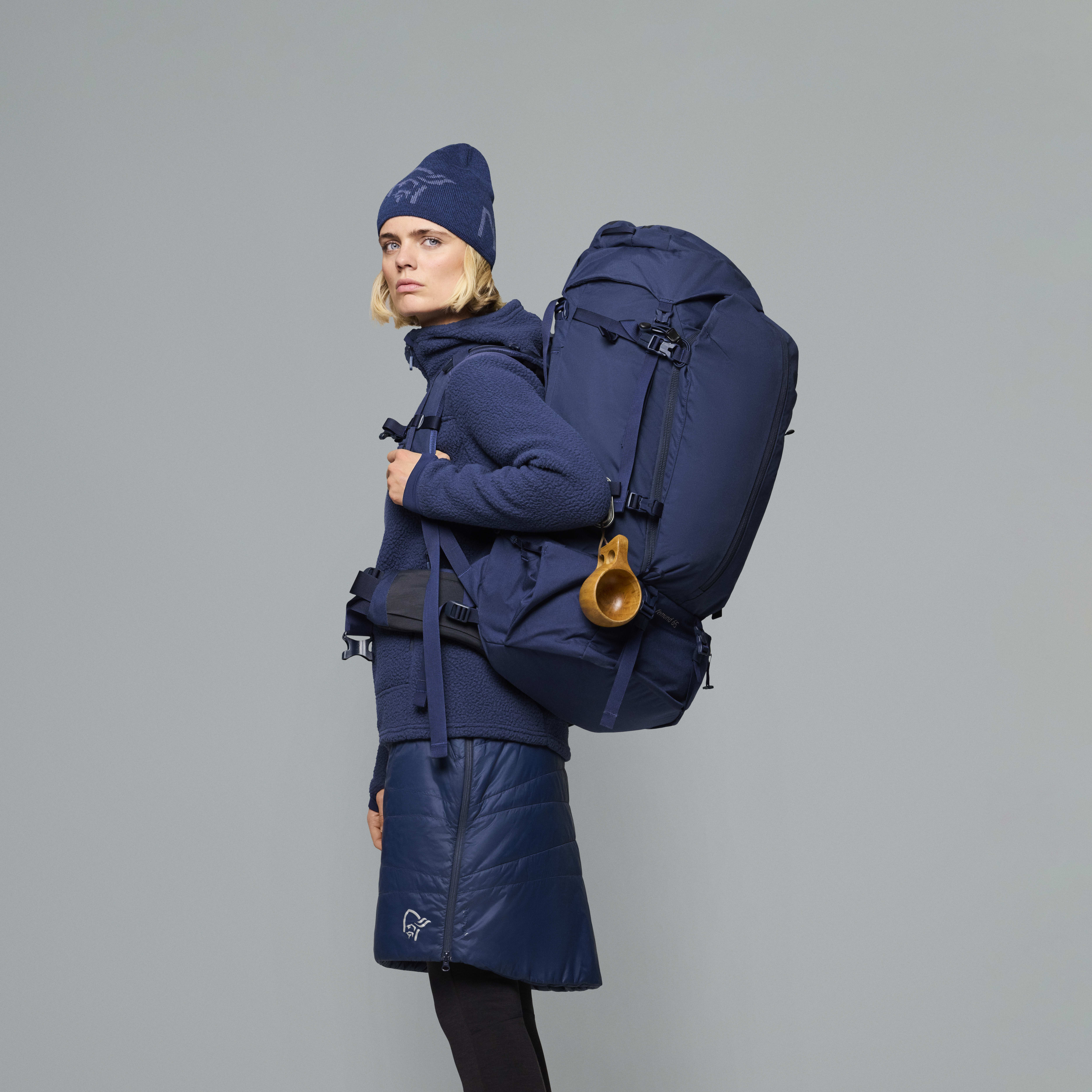 Female Look back image of femund synkron4 65L Pack Indigo Night
