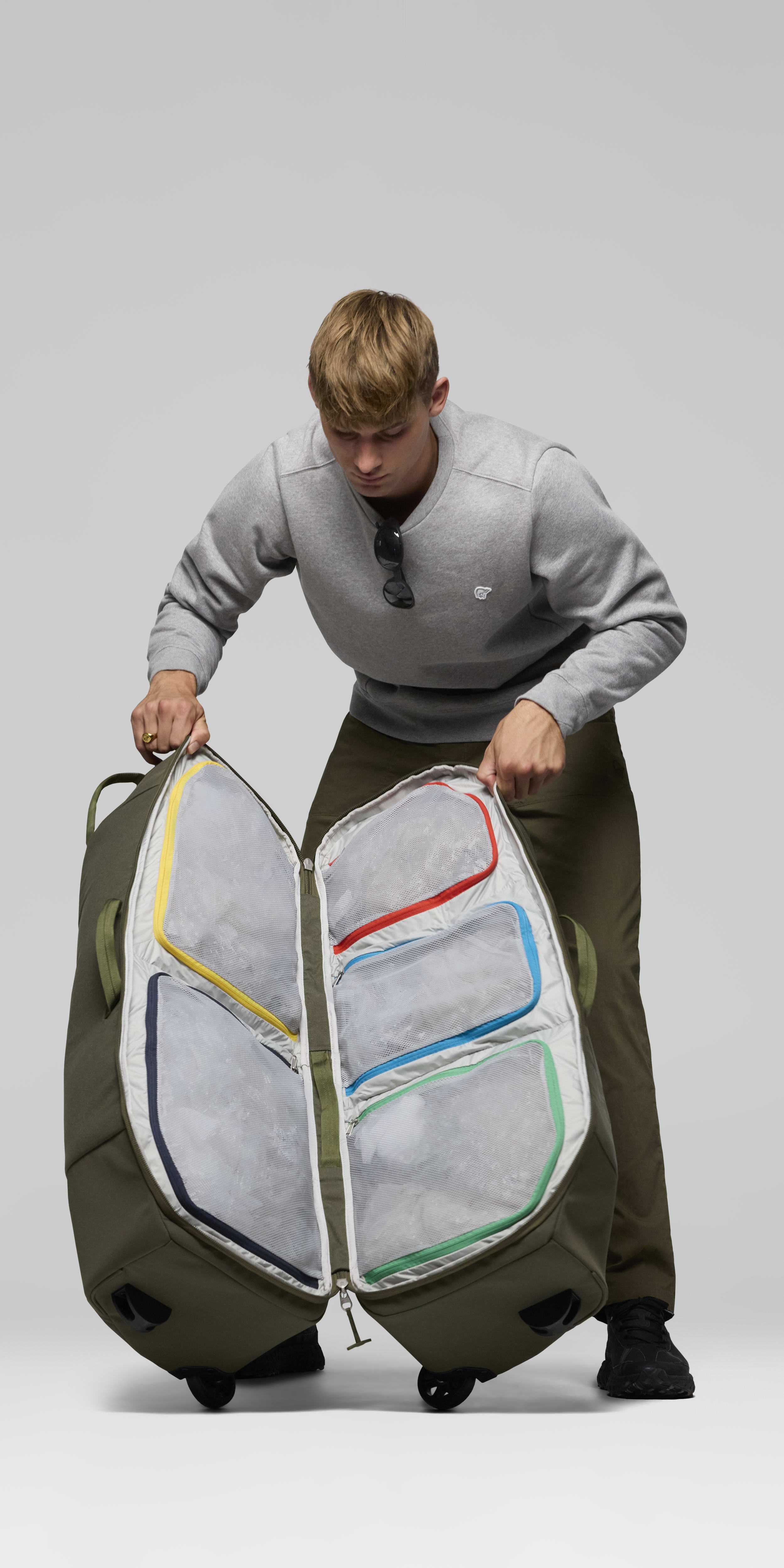 Female Look back image of norrona dividable 125L Trolley Bag Olive Night
