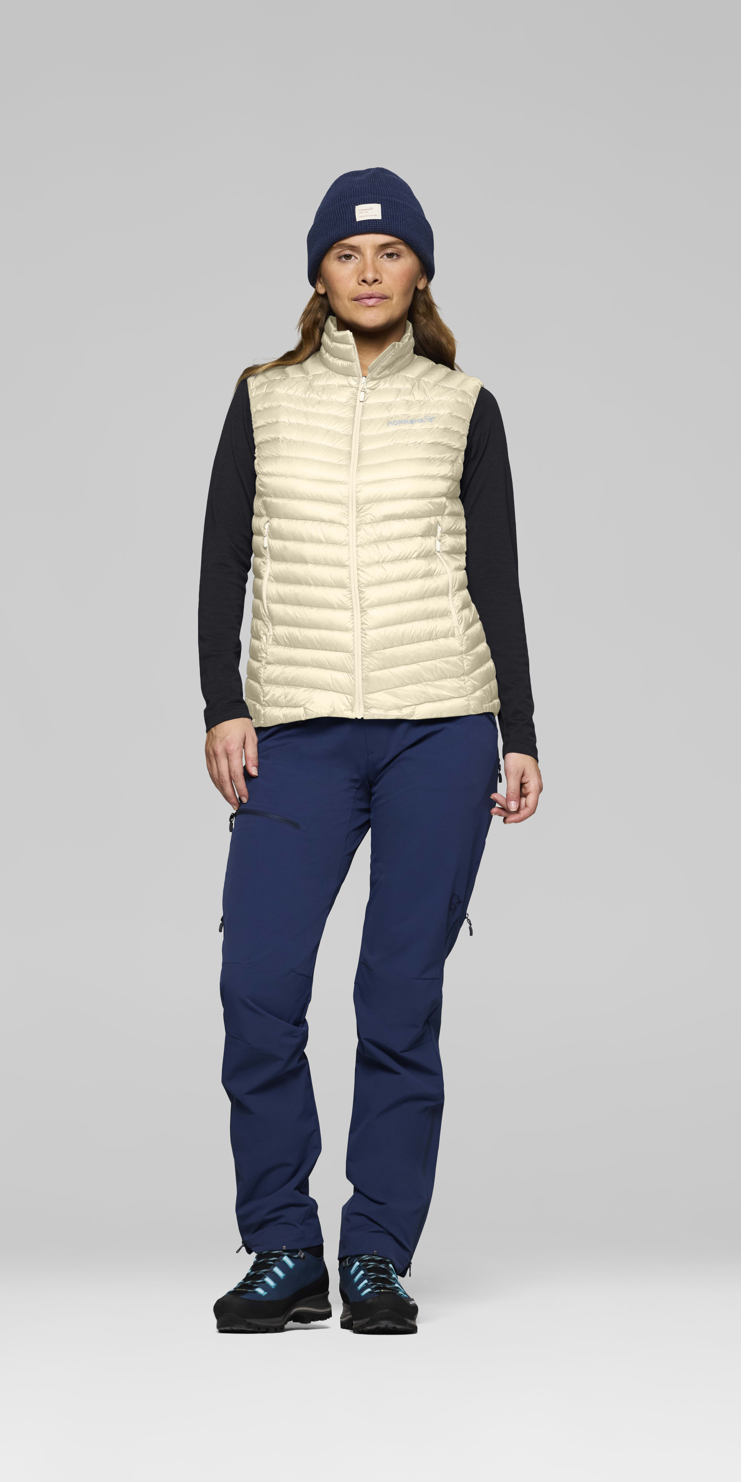 Female Look front image of trollveggen down800 super light Vest Whisper White