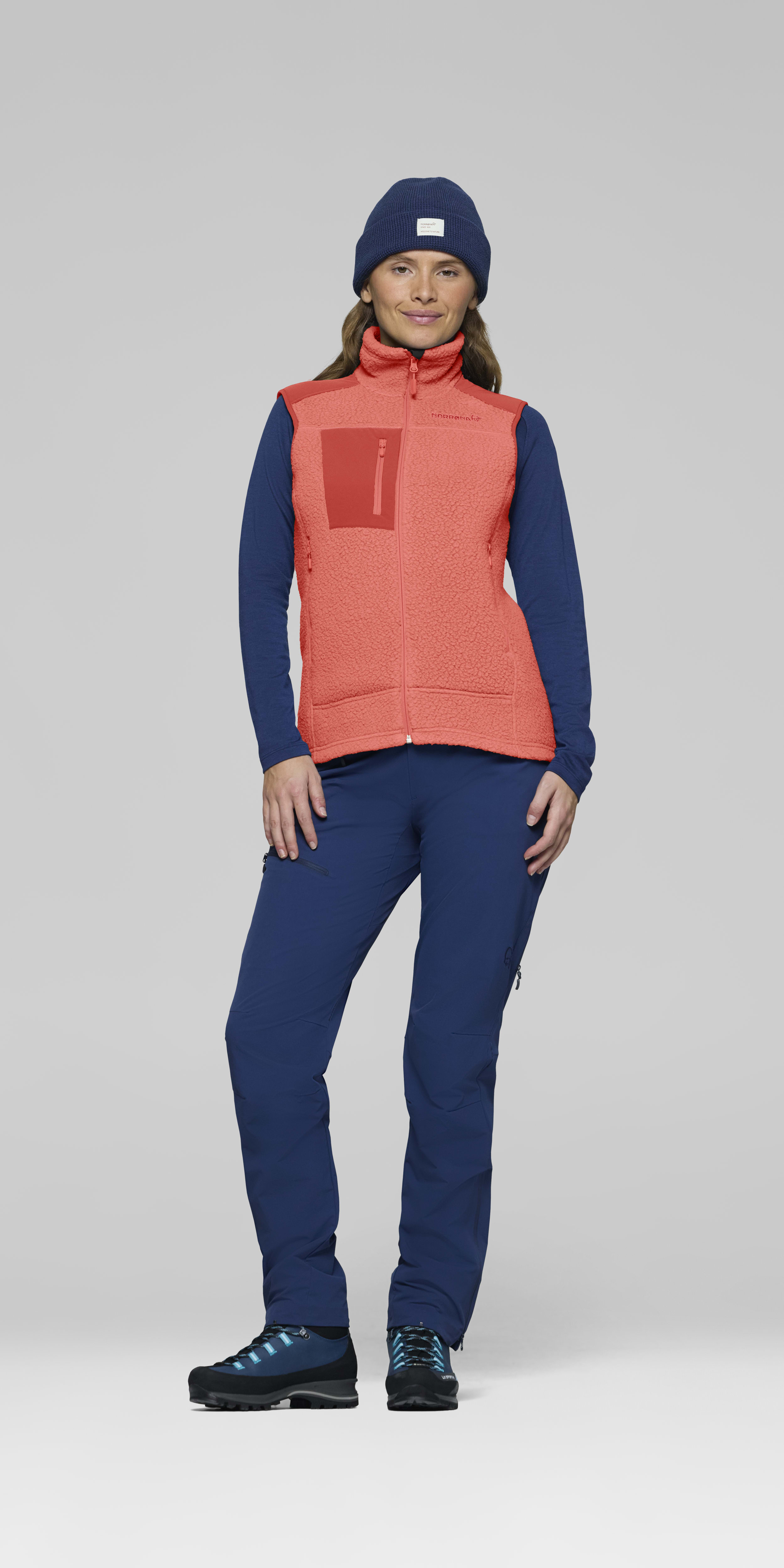 Female Look front image of trollveggen warm3 Vest Deep Sea Coral/Baked Apple