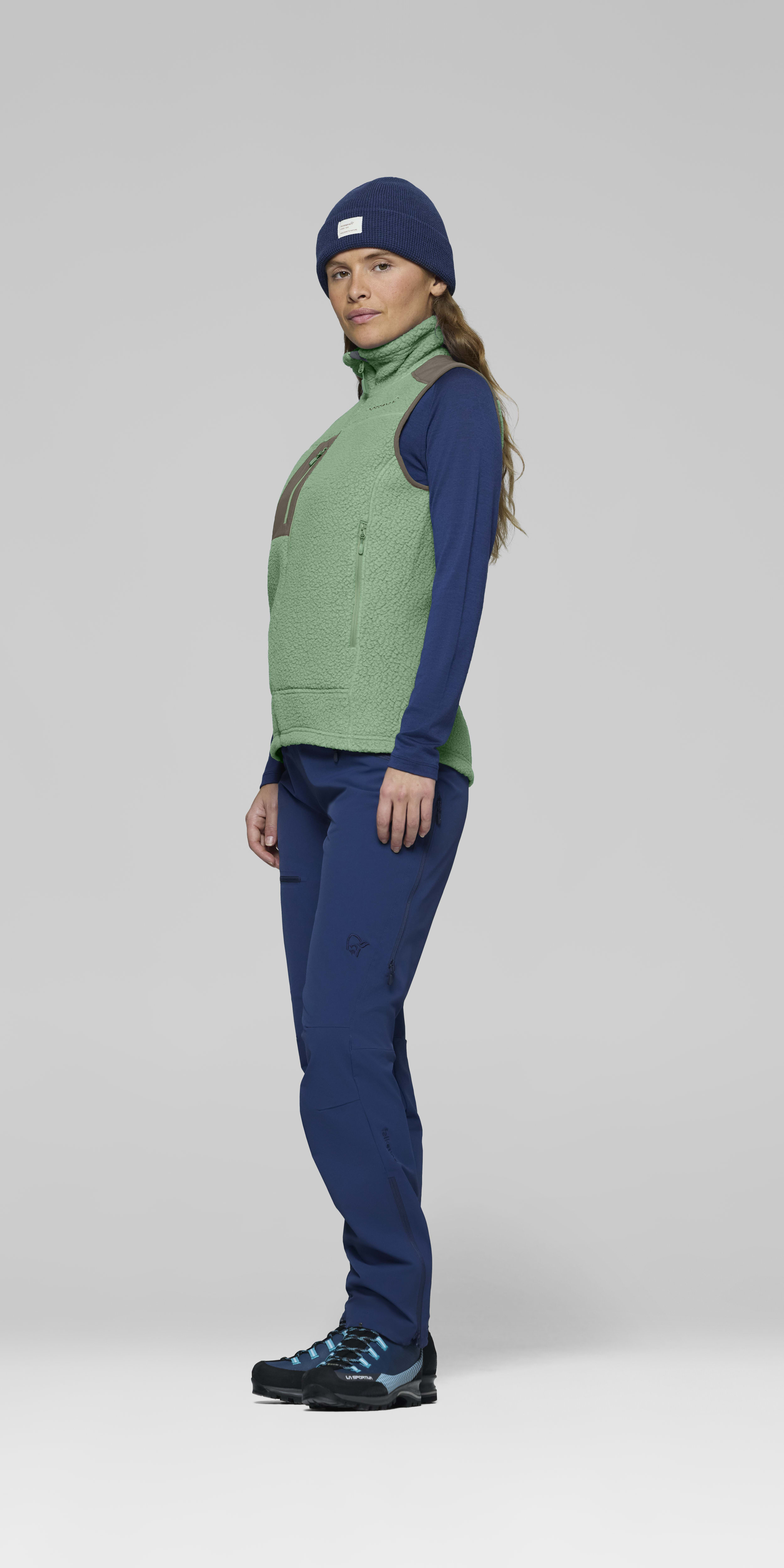 Female Look side image of trollveggen warm3 Vest Dark Ivy