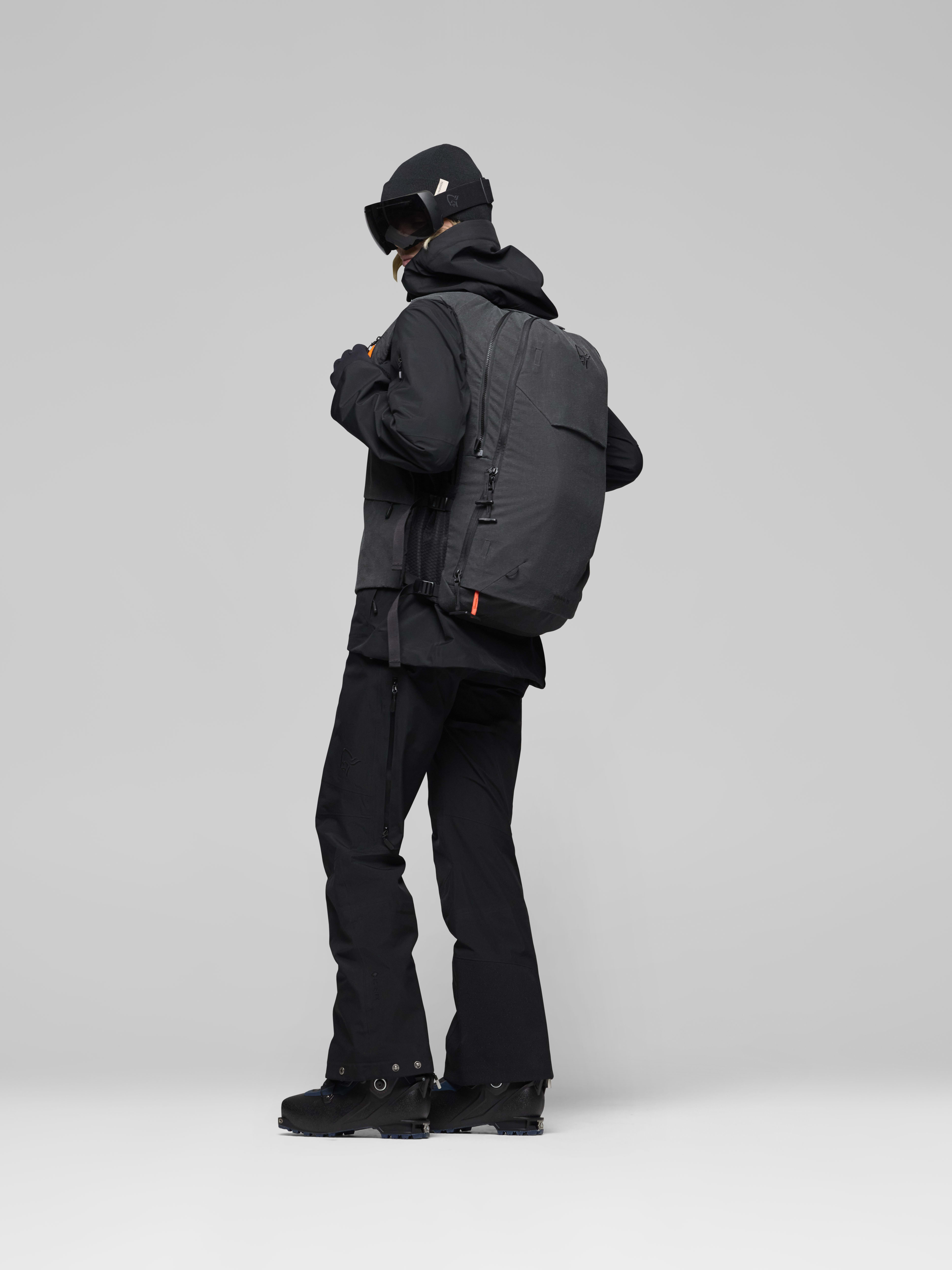 Female Look side image of lofoten Avi ACE 15L Pack Caviar Black