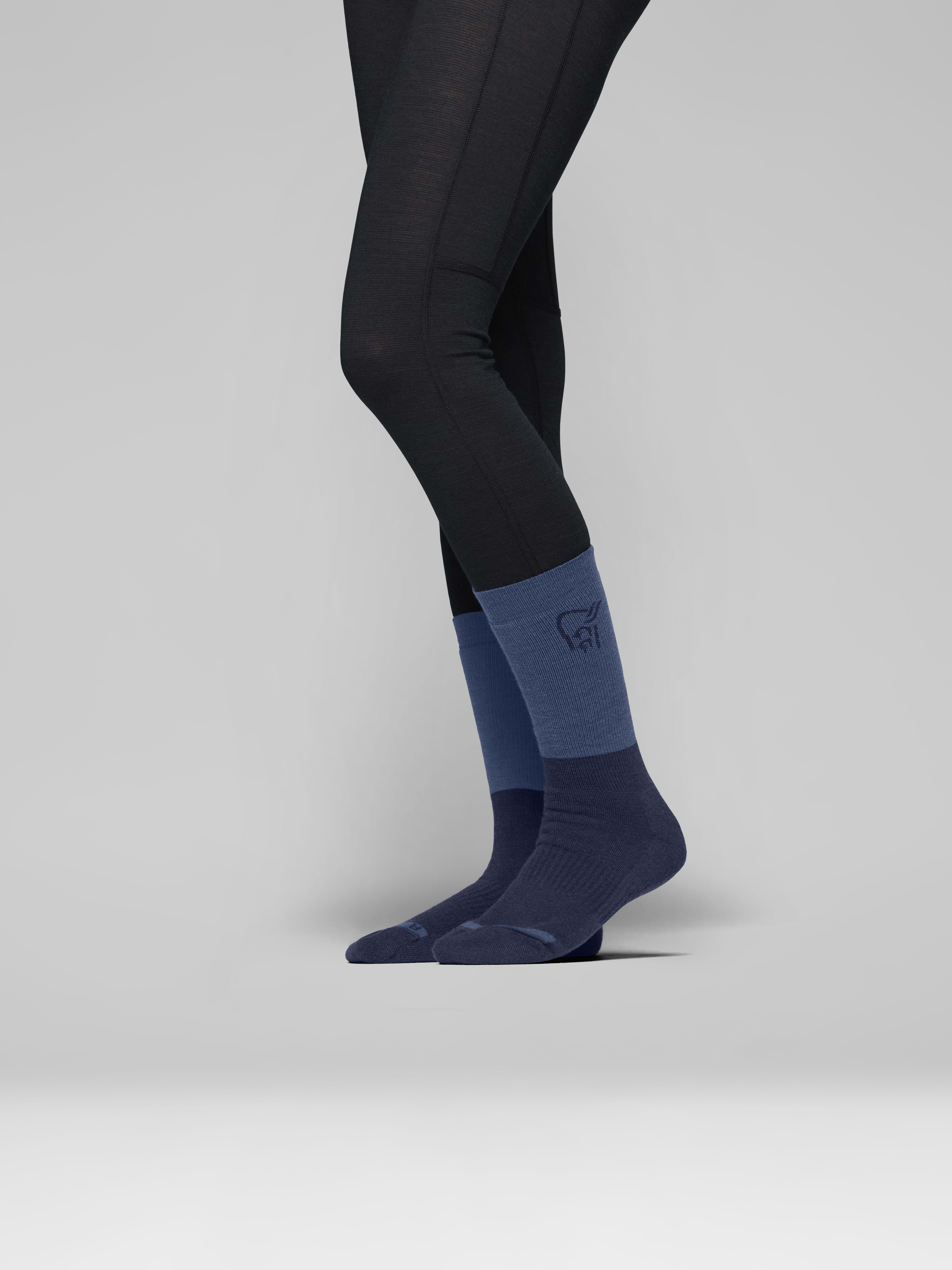 Female Look side image of trollveggen heavy merinoUll Socks Indigo Night/Dark Denim