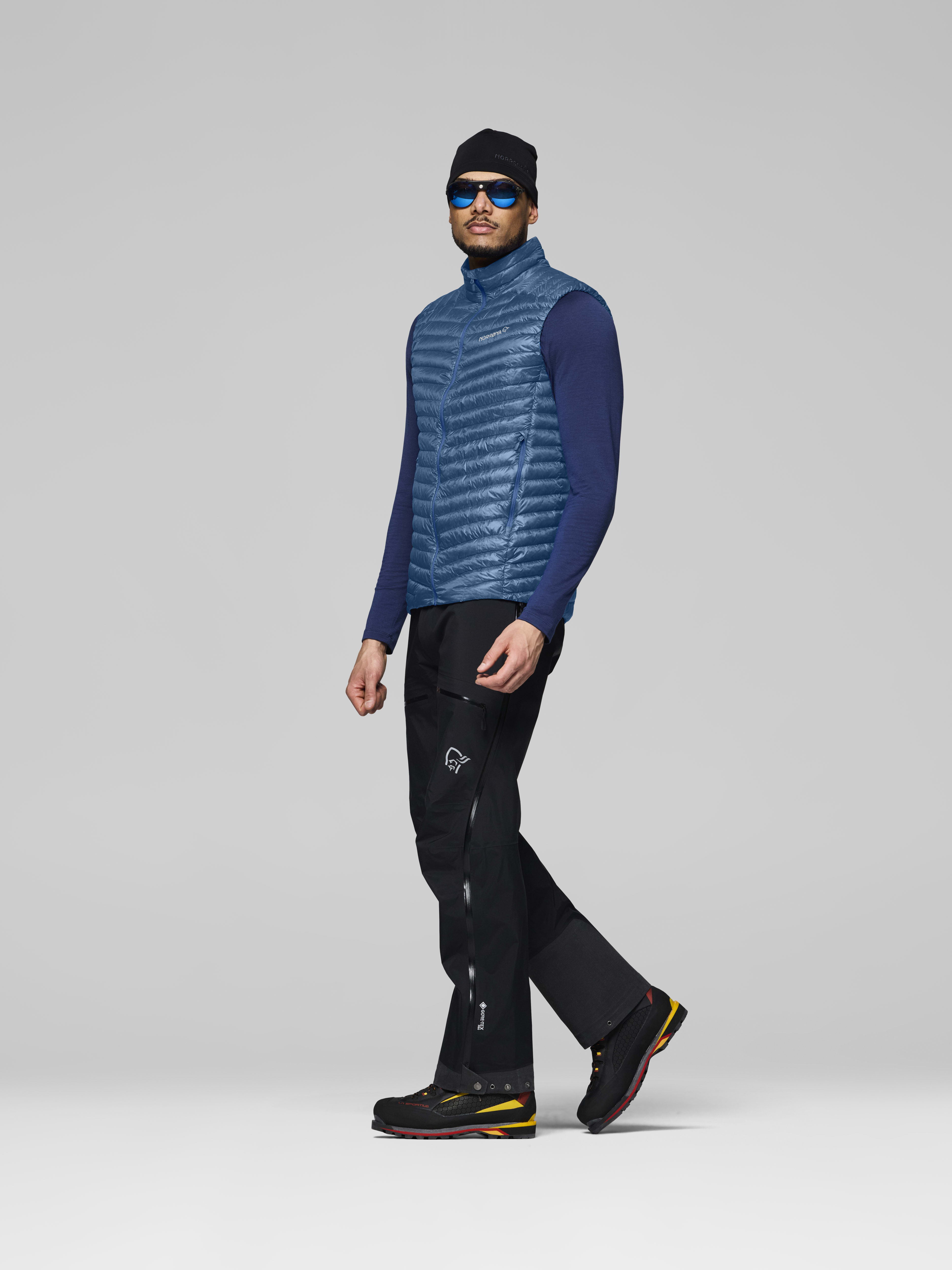 Male Look side image of trollveggen down800 super light Vest Dark Blue