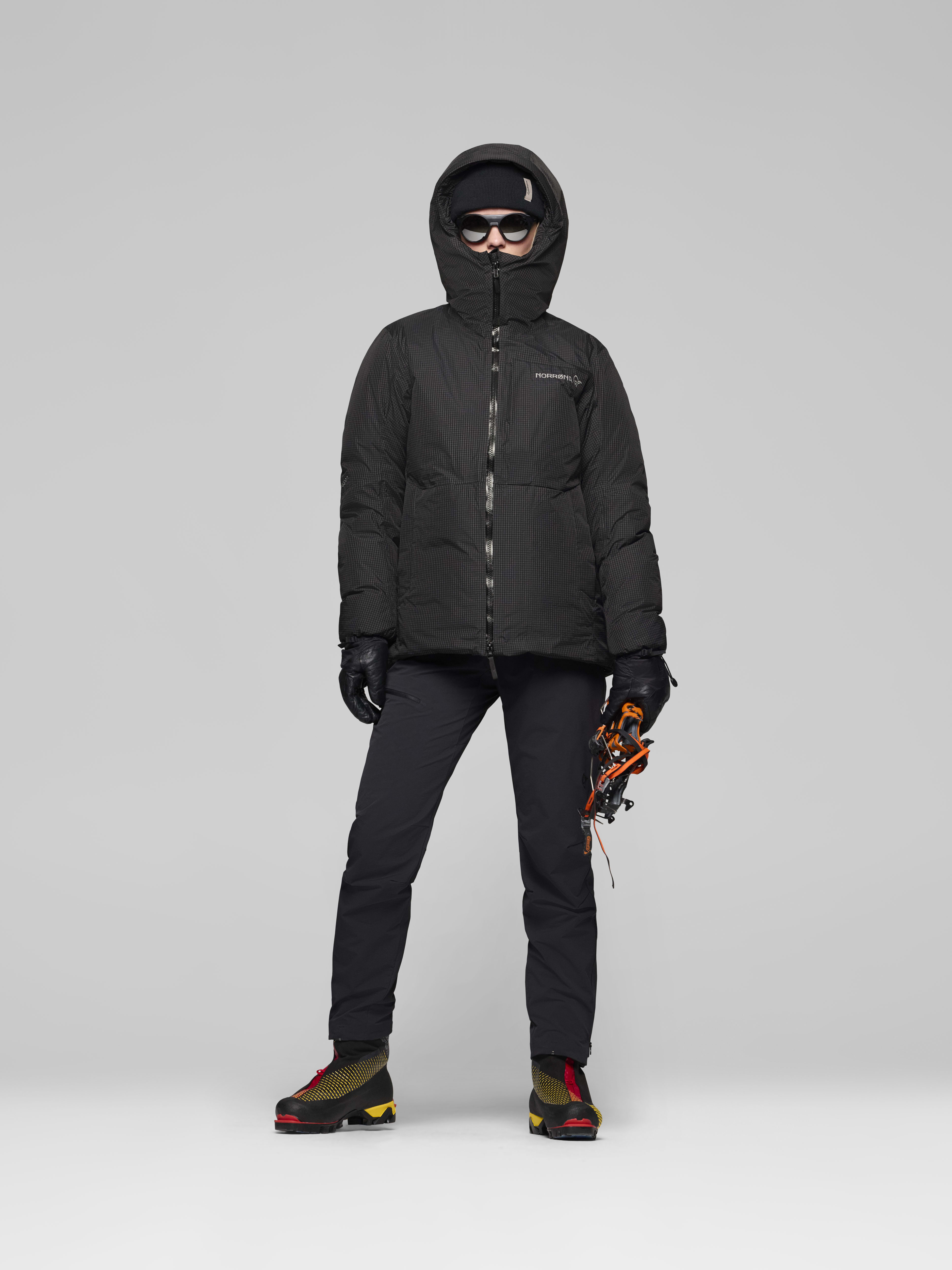 Female Look opening image of trollveggen dri2 down800 Zip Hood Caviar Black