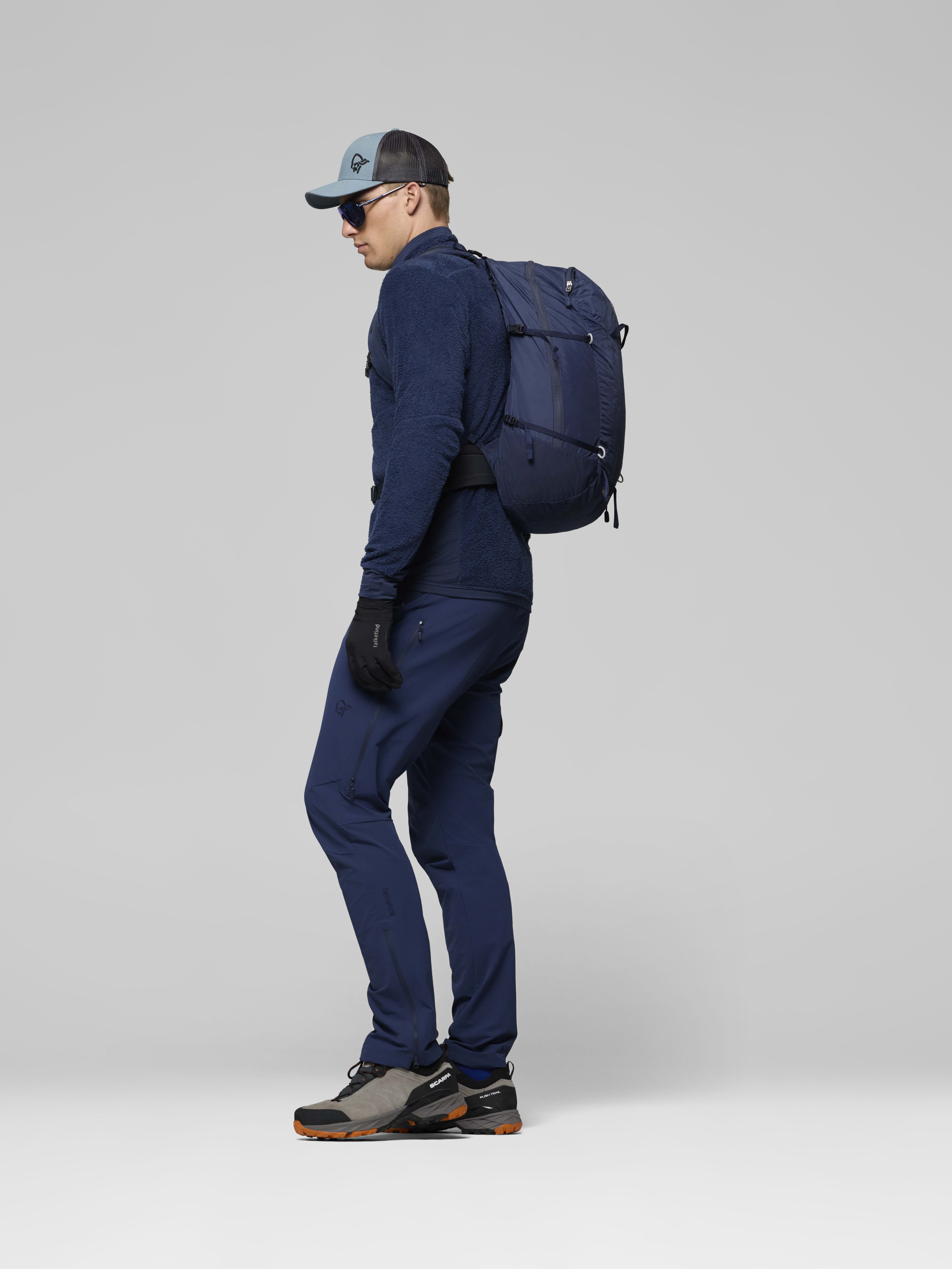 Female Look side image of falketind econyl70 28L Pack Indigo Night