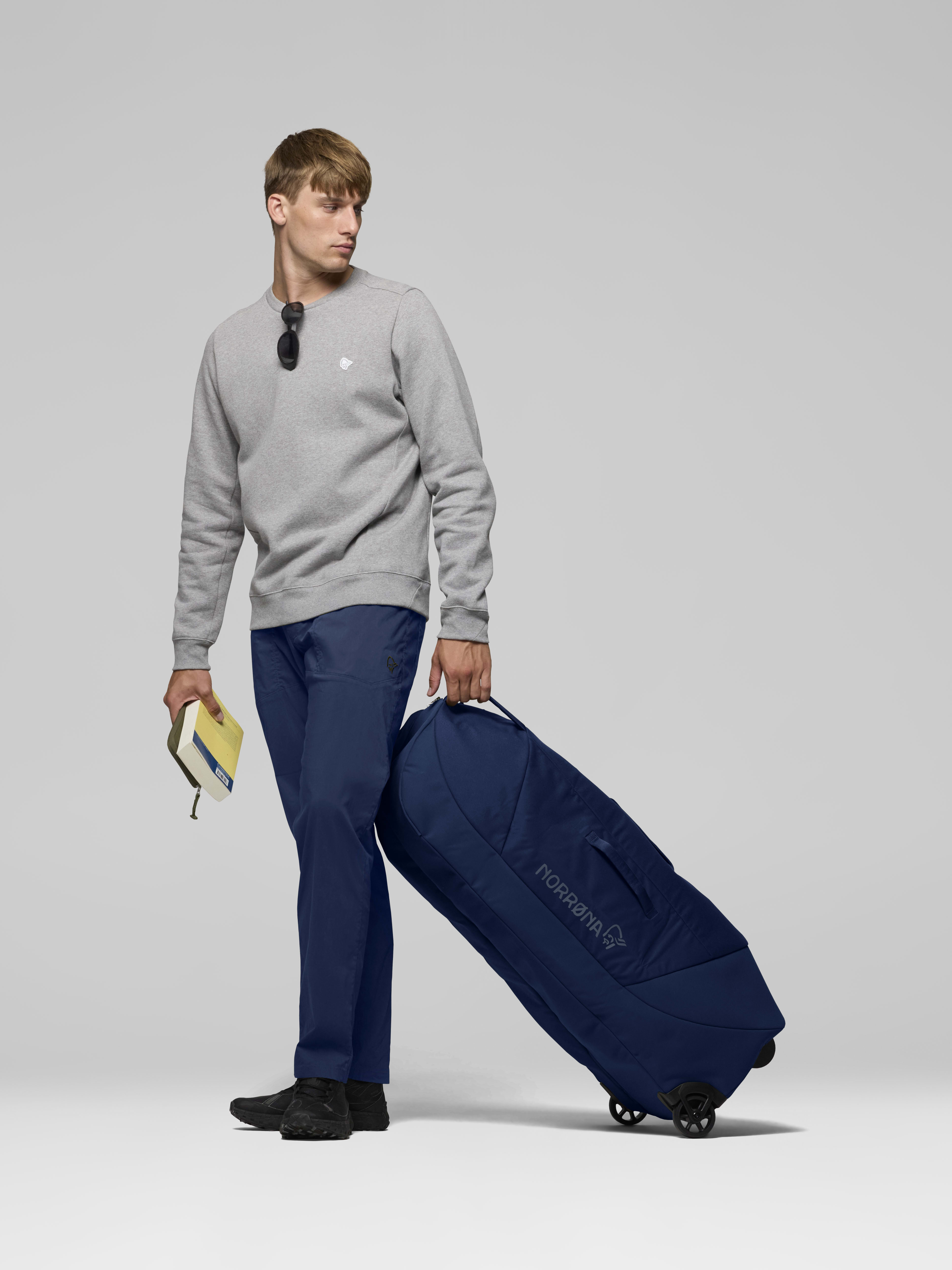 Female Look opening image of norrona dividable 125L Trolley Bag Indigo Night