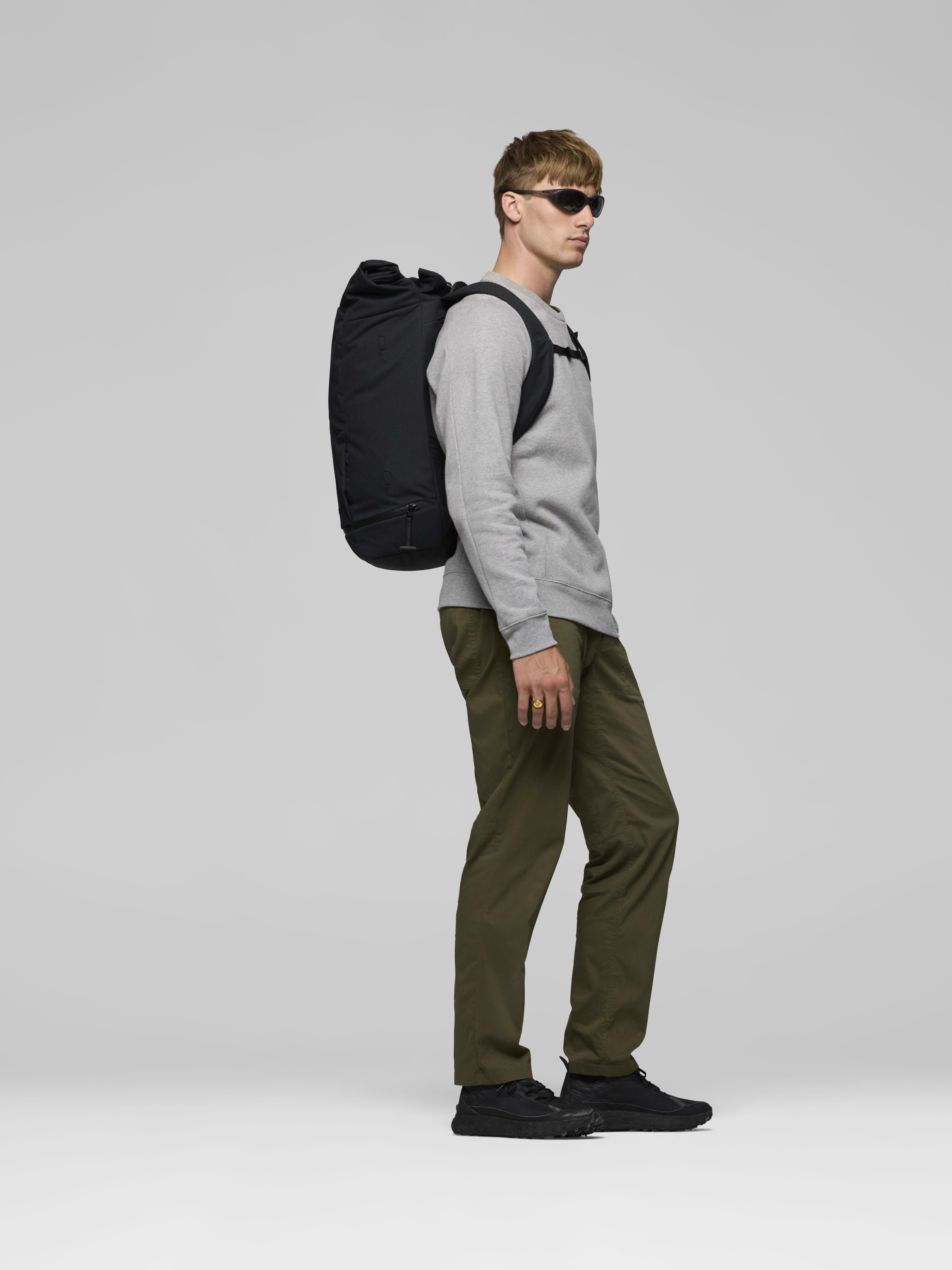 Female Look side image of norrona commuter 35L Pack Caviar Black