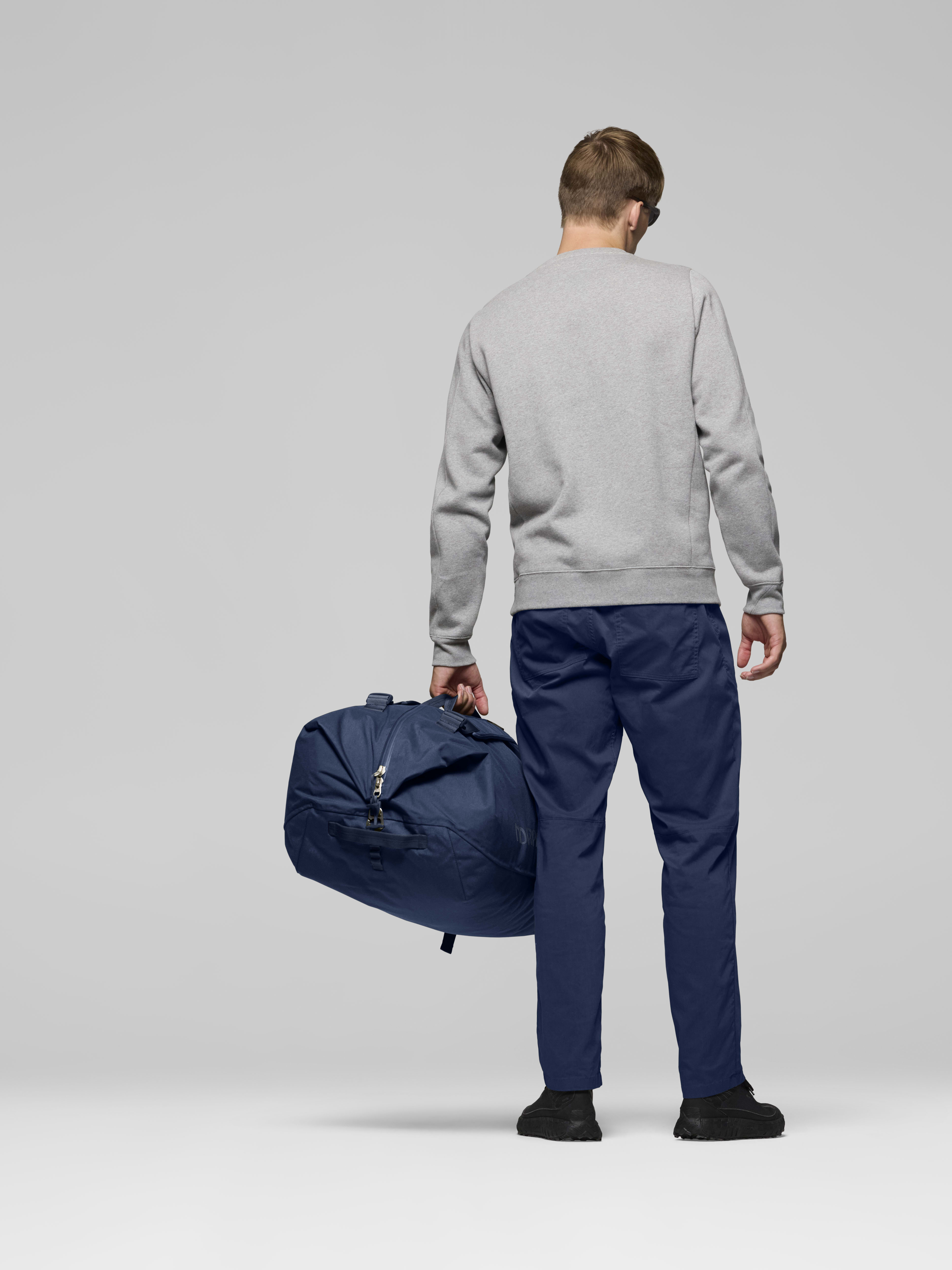 Female Look back image of norrona 90L Duffel Bag Indigo Night