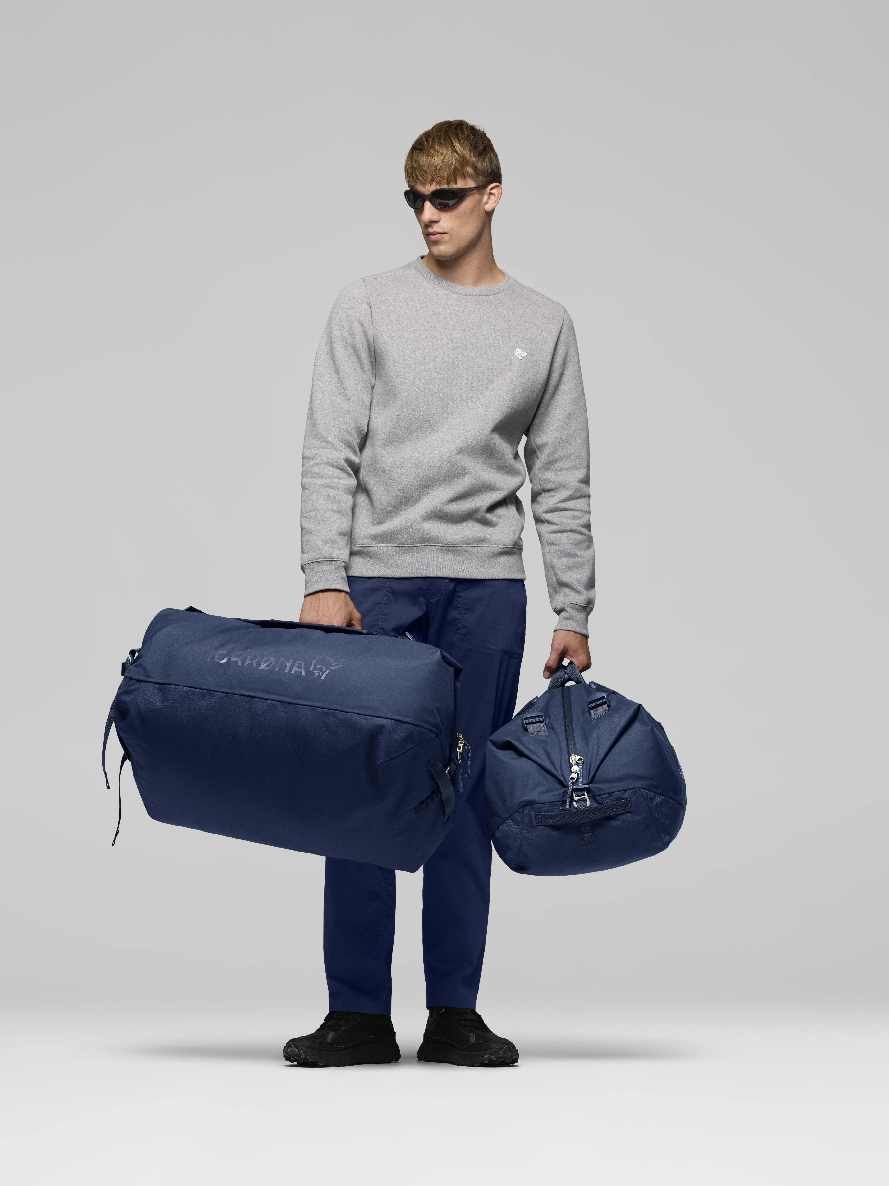 Female Look opening image of norrona 90L Duffel Bag Indigo Night