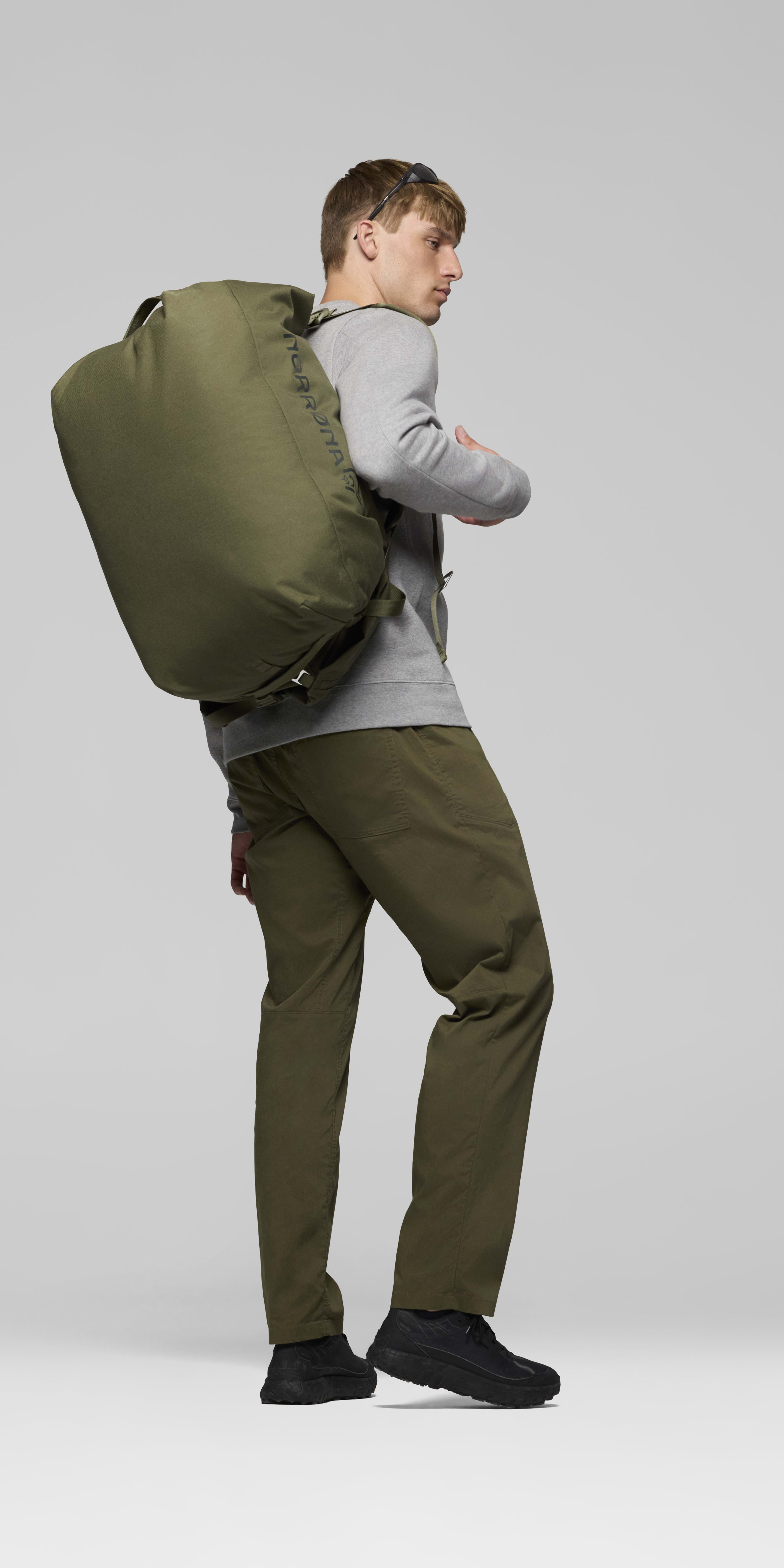 Female Look back image of norrona 70L Duffel Bag Olive Night