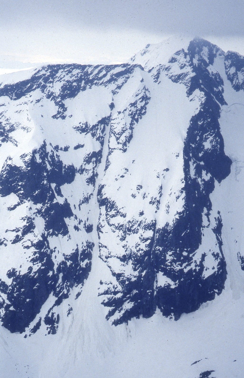 Aerial view of a snowy mountain range. 
