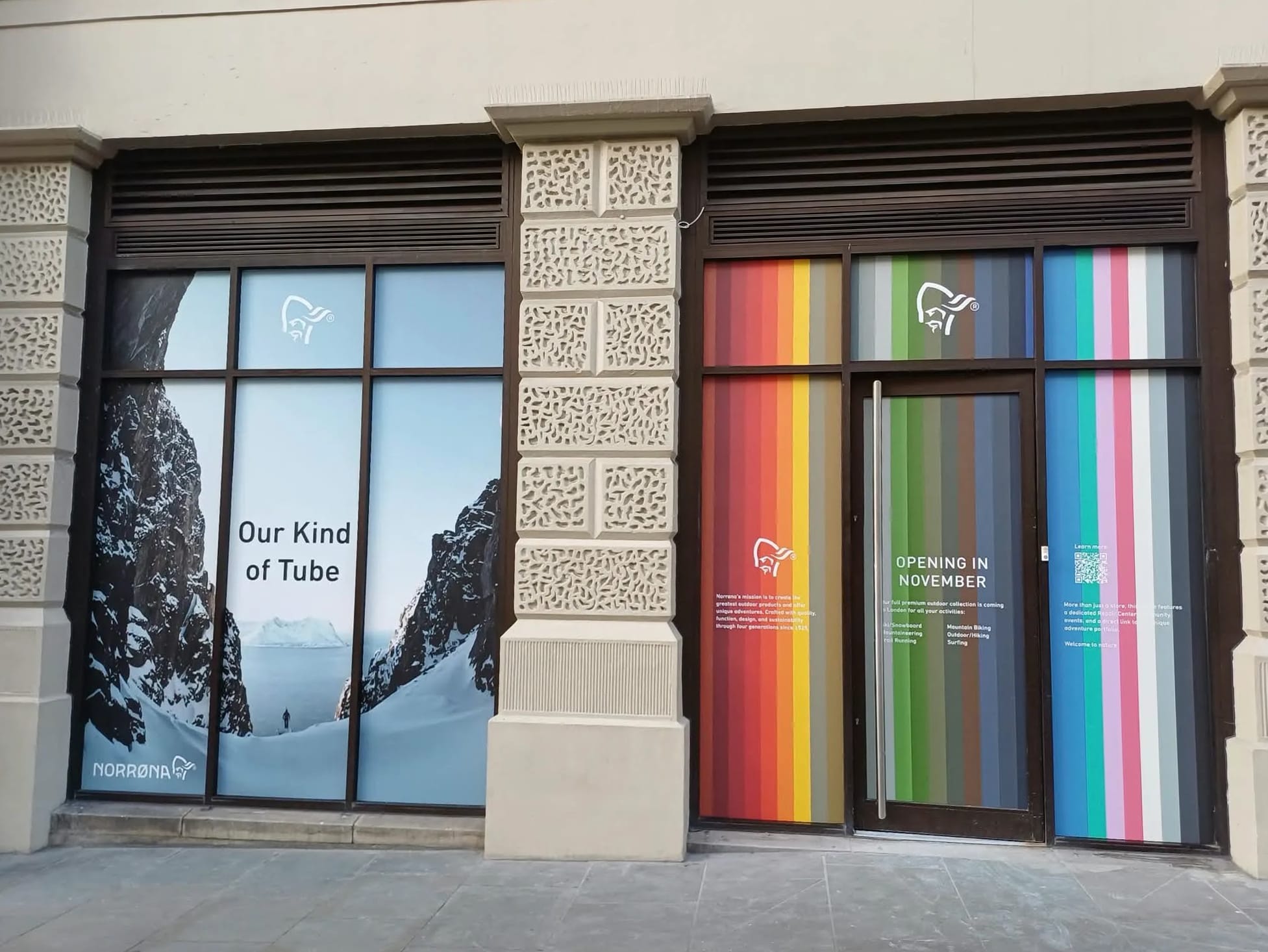 Norrøna storefront with a colorful striped display reading "Opening in November" and a snowy mountain graphic.