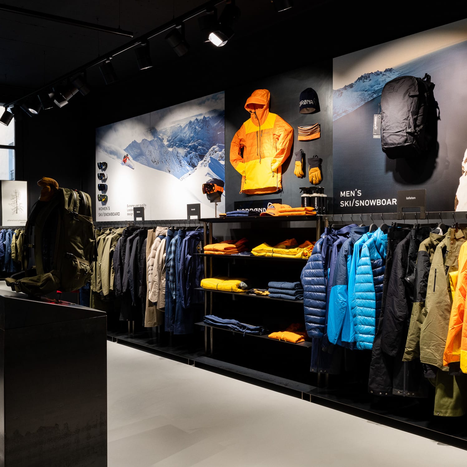 A Norrøna store with clothing, backpacks, and other ski and snowboard gear displayed.  
