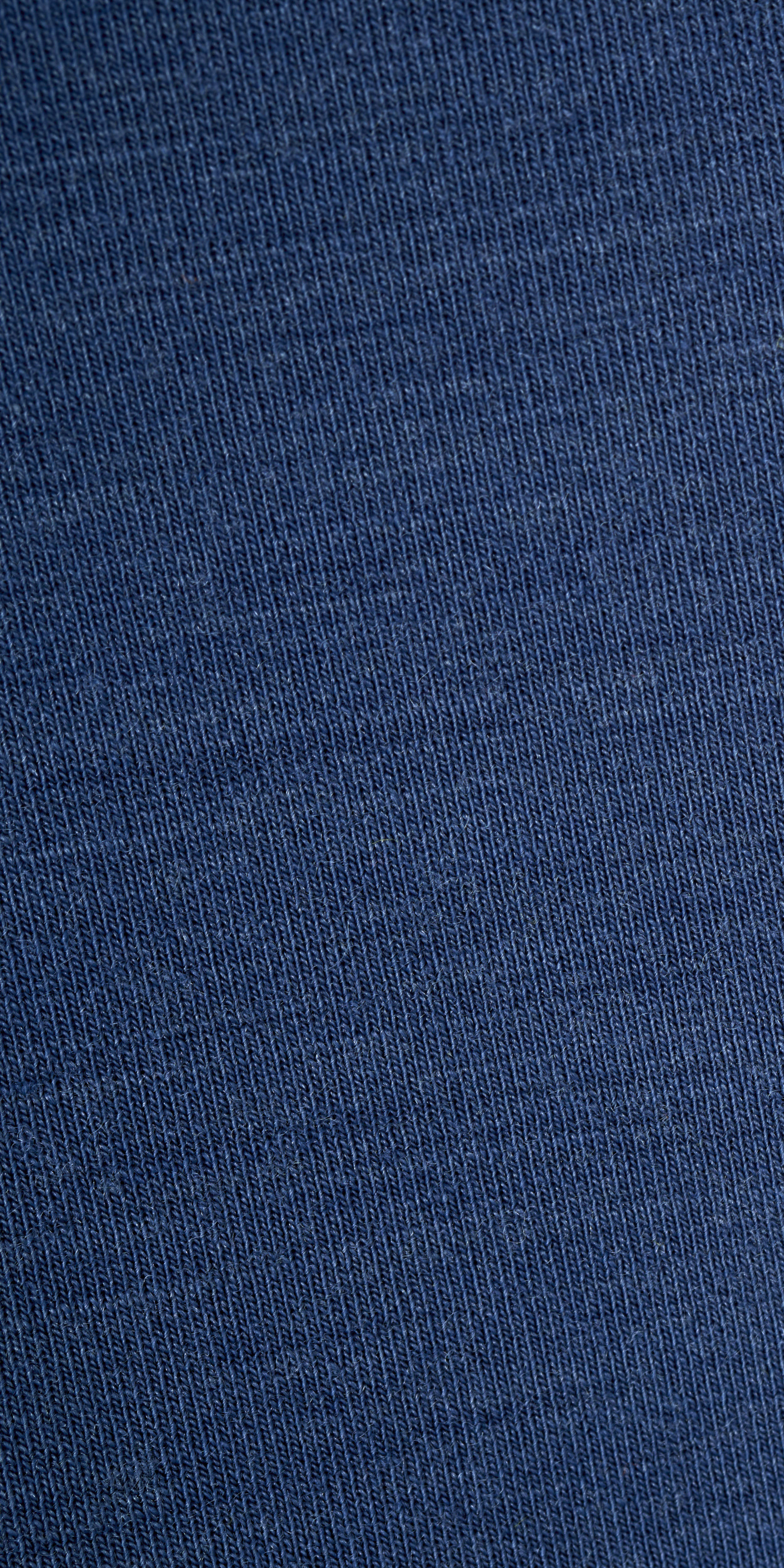 Close-up of a Norrøna garment's blue fabric. 
