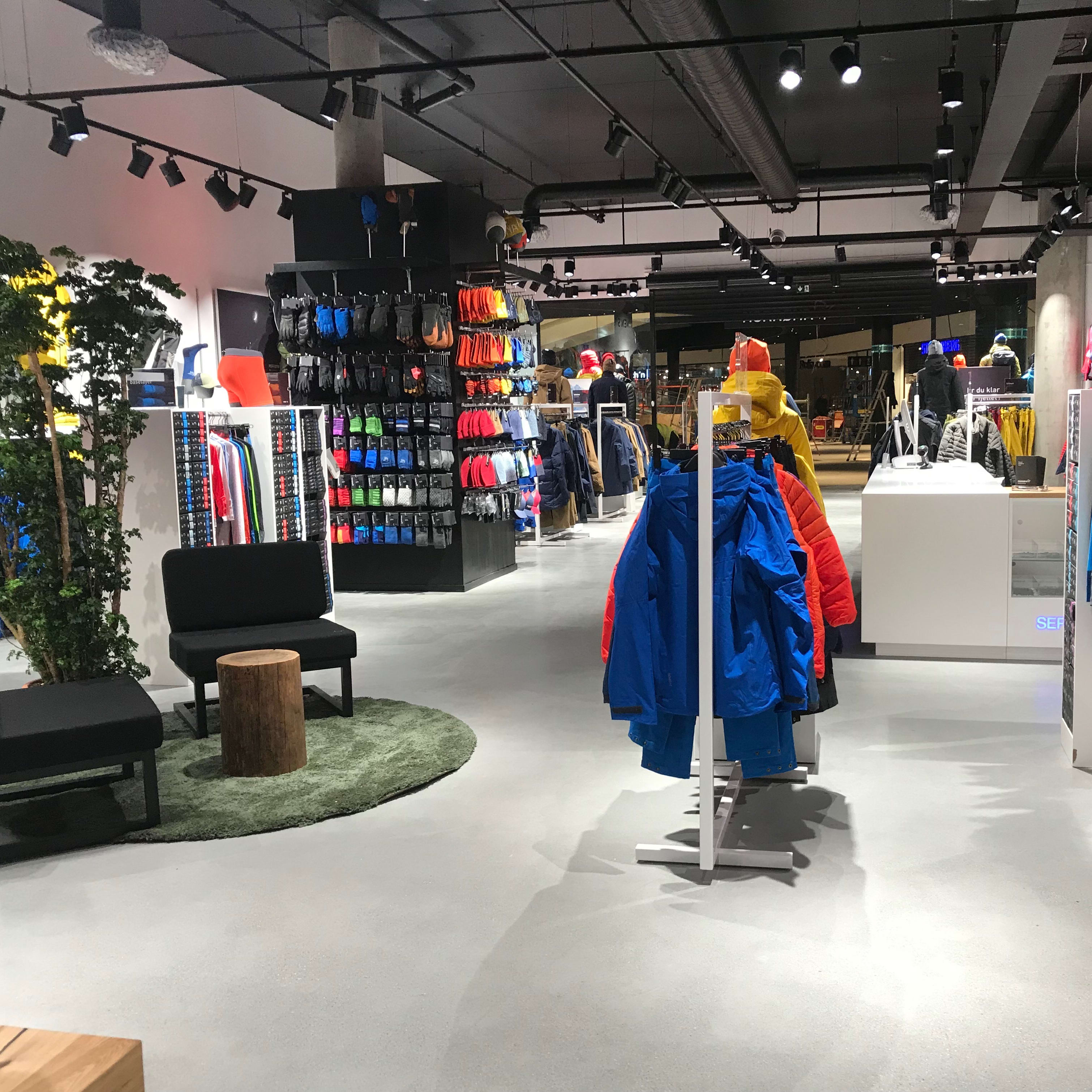 Interior of a Norrøna store featuring colorful outdoor jackets and clothing on display racks.