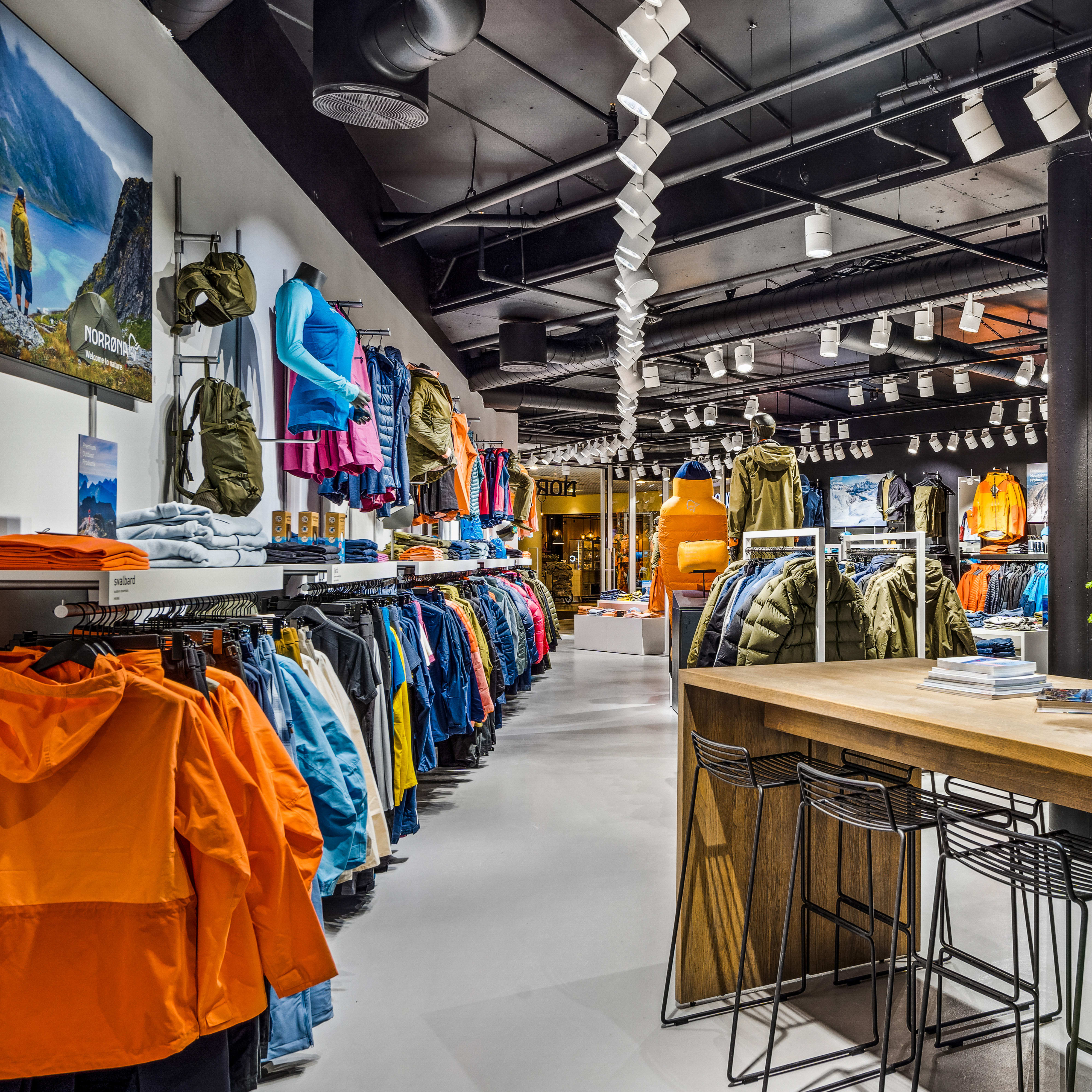 Interior of a Norrøna retail store displaying outdoor clothing and gear.