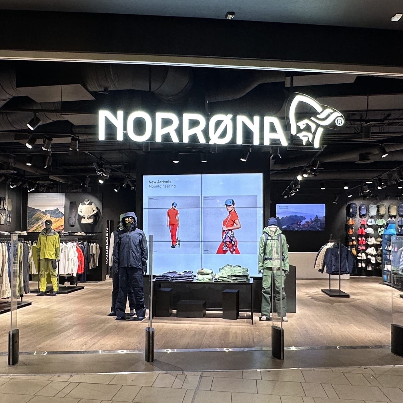 Storefront of Norrøna featuring mannequins and video displays showcasing outdoor apparel and gear from the Spring/Summer 2026 and Lofoten collections.